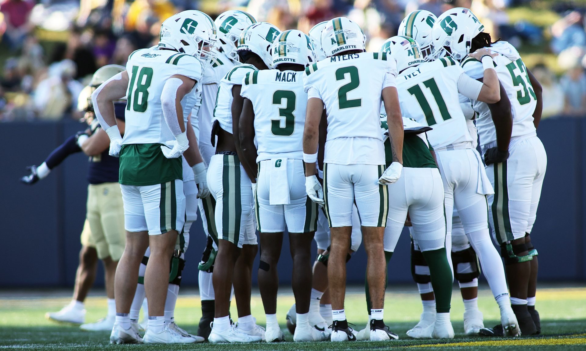 Charlotte 49ers players huddle up during the second half against the Navy Midshipmen at Navy-Marine Corps Memorial Stadium.