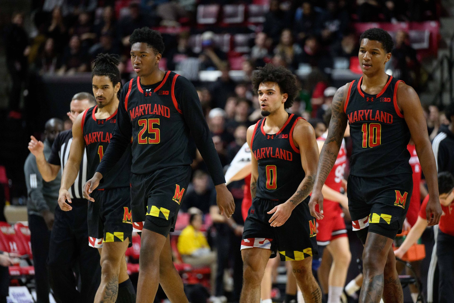 Maryland Terrapins guard Rodney Rice (1), center Derik Queen (25), guard Ja'Kobi Gillespie (0), and forward Julian Reese (10) walk to the bench during the first half against the Rutgers Scarlet Knights at Xfinity Center.