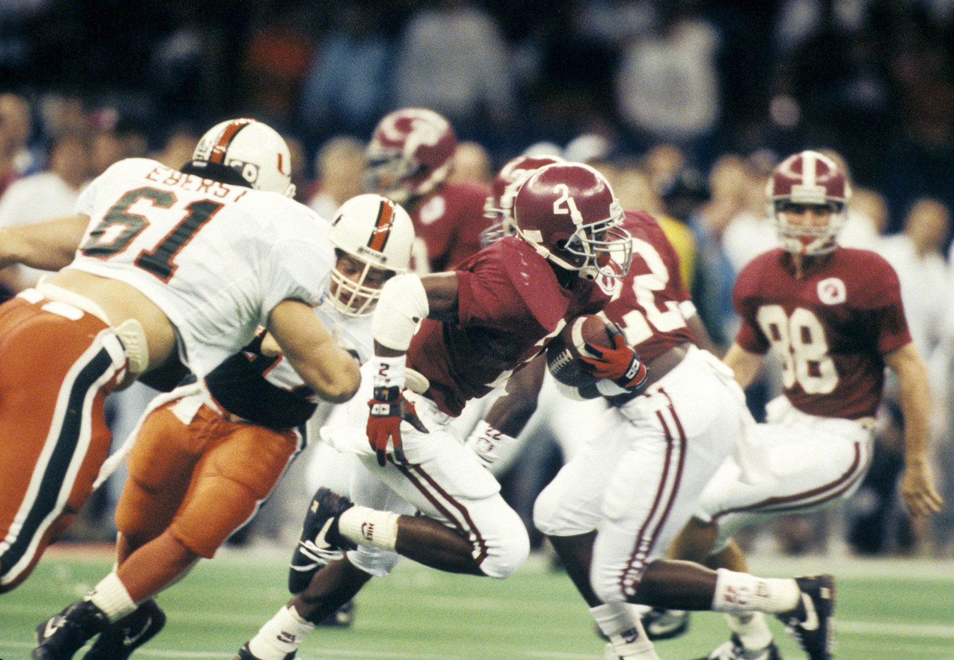 Alabama Crimson wide receiver David Palmer (2) carries the ball past teammate Dabo Swinney (88) against the Miami Hurricanes  during the 1993 Sugar Bowl at the Superdome.  Alabama defeated Miami 34-13 to win the national championship.