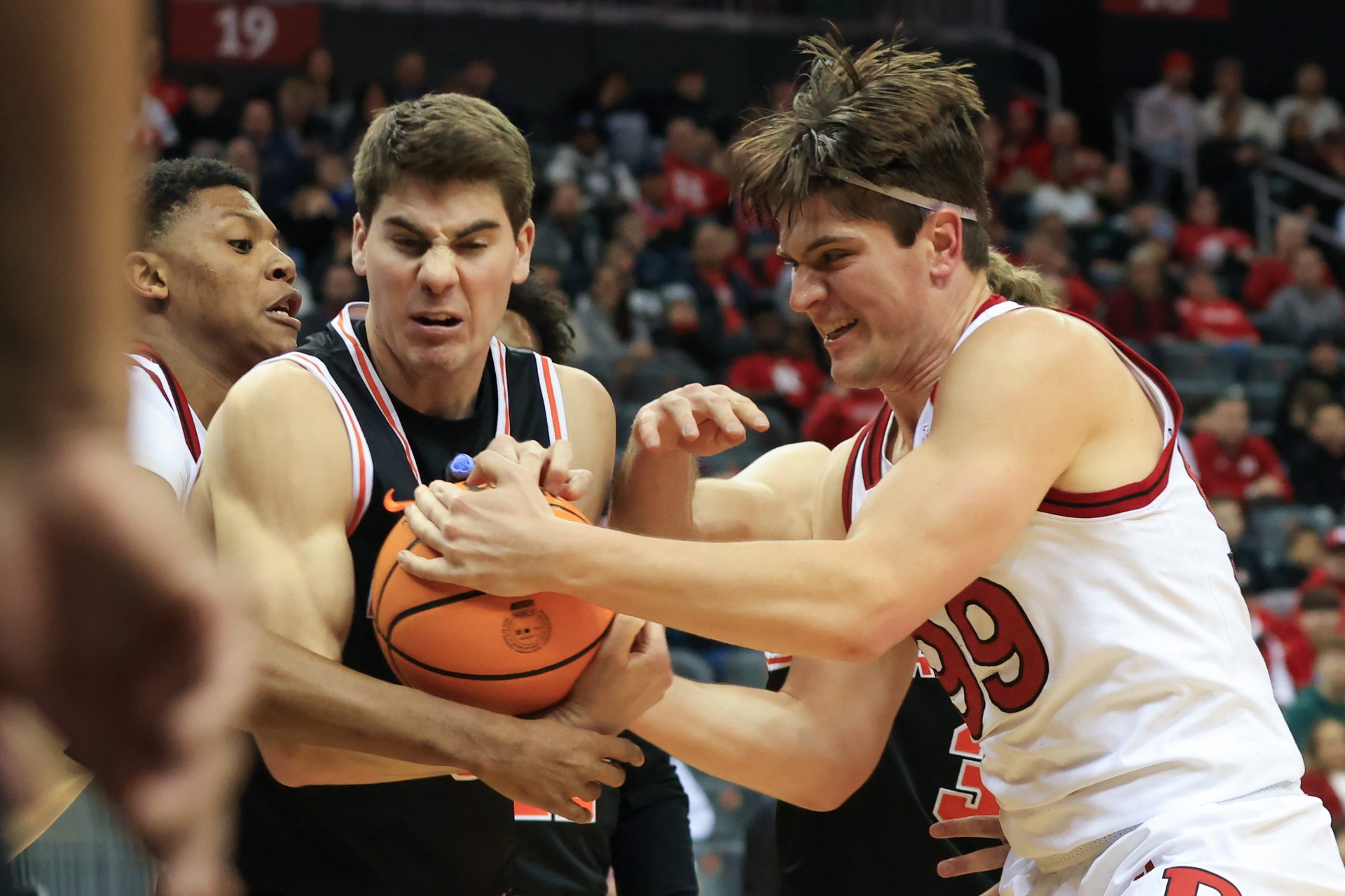 Princeton Tigers guard Jack Scott (9) and Rutgers Scarlet Knights center Zach Martini (99) battle for the rebound during the first half at Prudential Center.