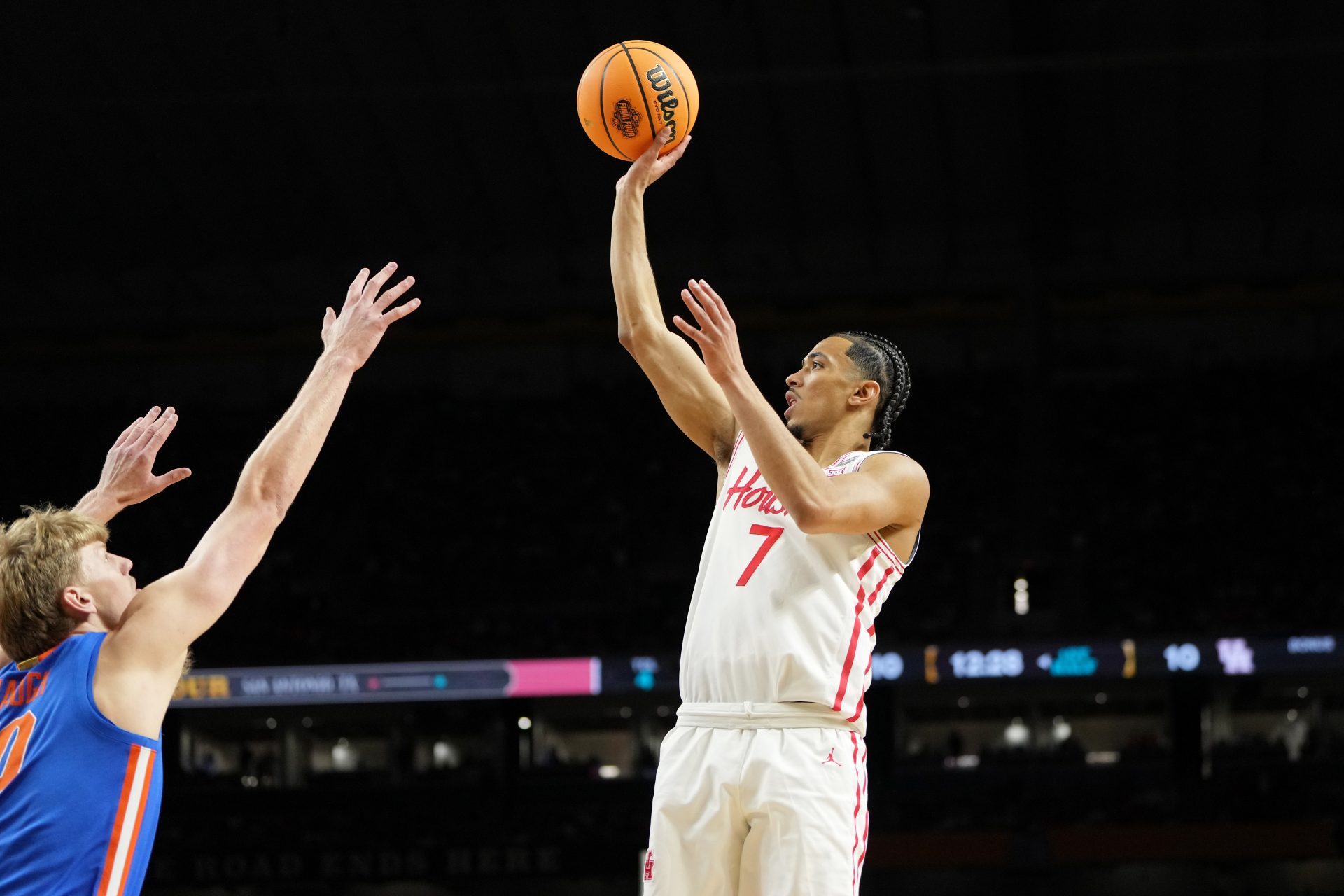 Houston Cougars guard Milos Uzan (7) shoots the ball against Florida Gators forward Thomas Haugh (10) during the first half of the national championship game of the Final Four of the 2025 NCAA Tournament at the Alamodome.