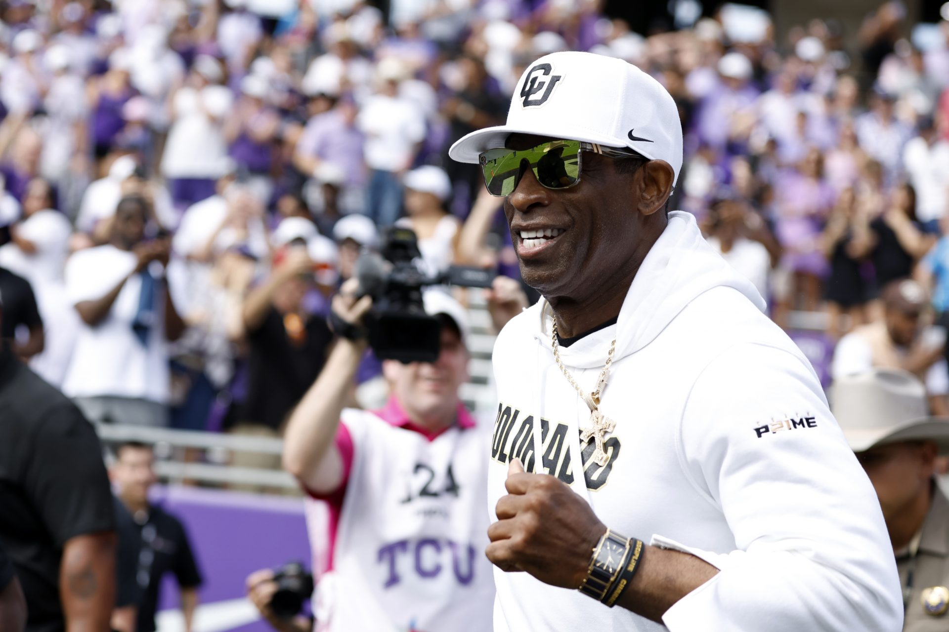 Colorado Buffaloes head coach Deion Sanders runs on the field before the game against the TCU Horned Frogs at Amon G. Carter Stadium.