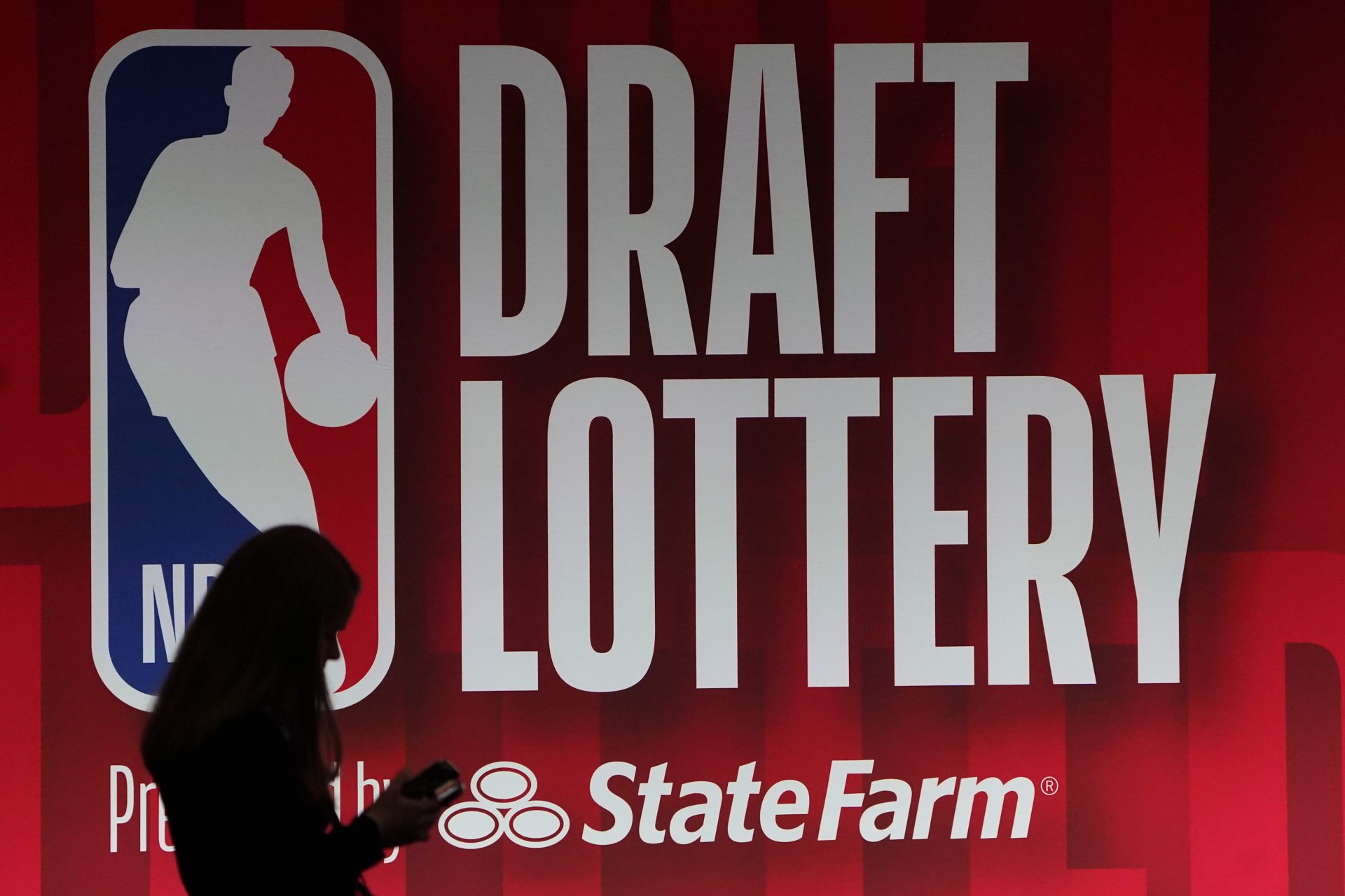 People walk past the 2023 NBA Draft Lottery board at McCormick Place West.