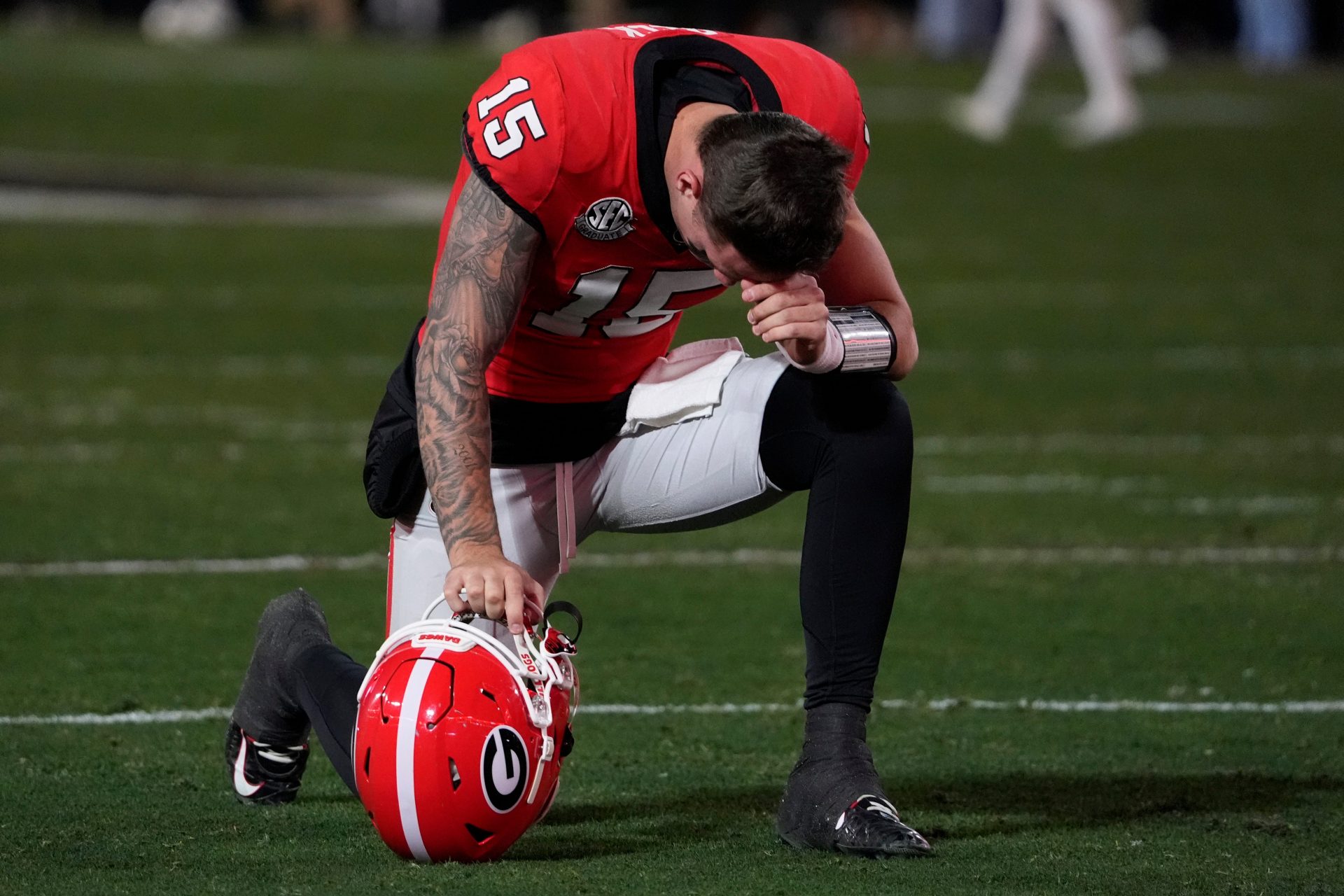 Georgia quarterback Carson Beck (15) prays before the start of the first half of a NCAA college football game against Georgia Tech