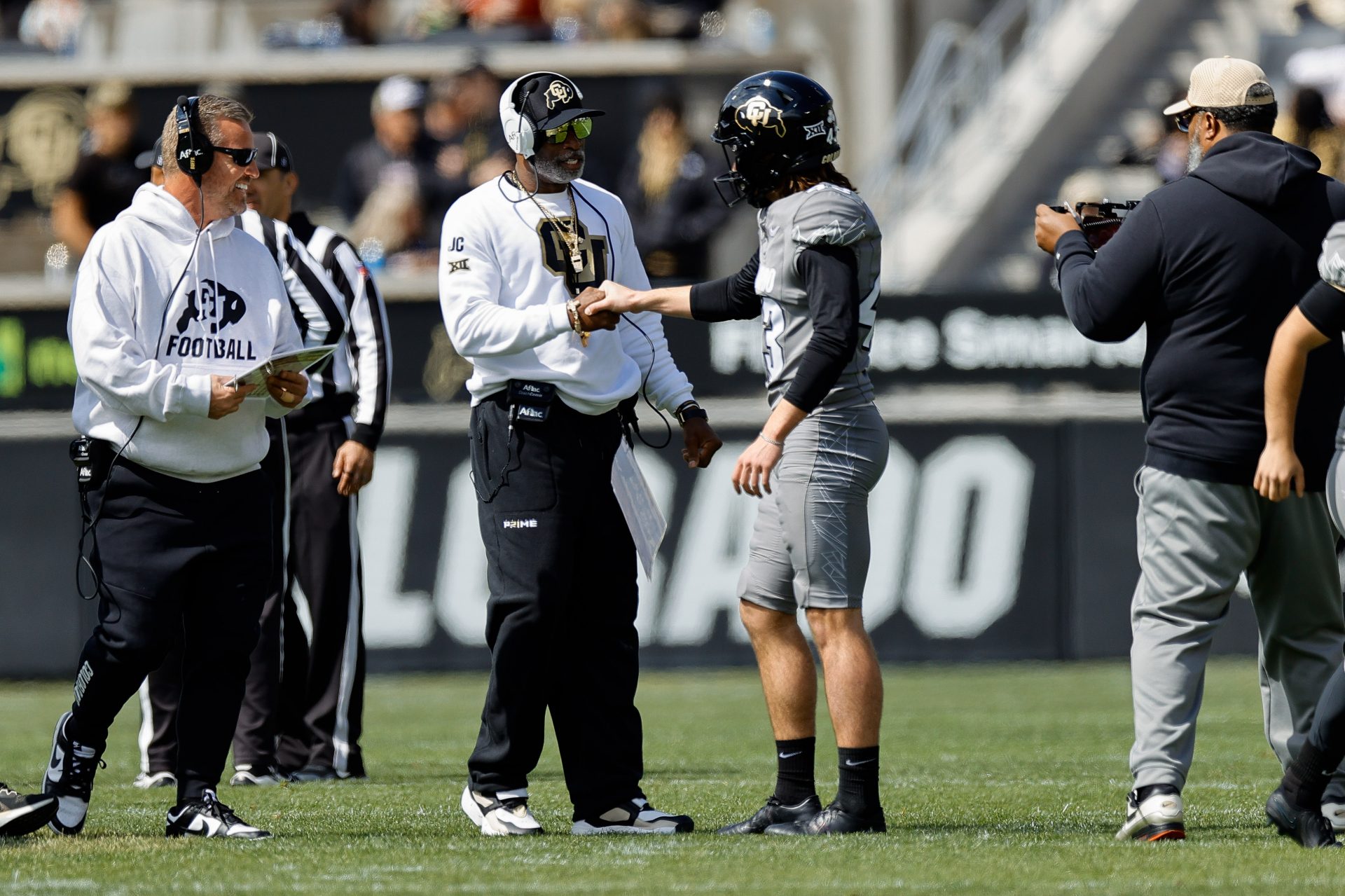 Colorado Buffaloes head coach Deion Sanders and place kicker Buck Buchanan (43) during the spring game at Folsom Field.