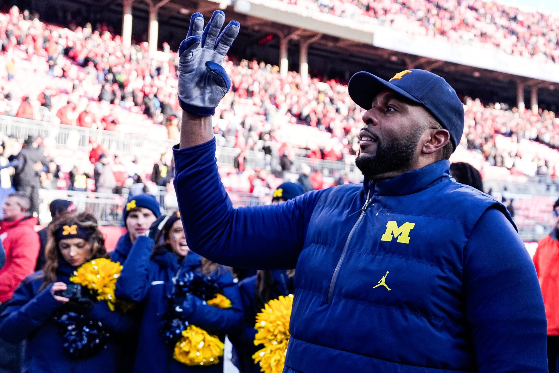 Michigan head coach Sherrone Moore uses a hand signal to celebrate the Wolverines' fourth straight win over Ohio State