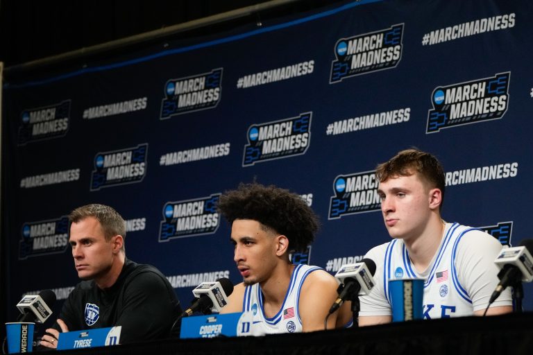 Duke Blue Devils head coach Jon Scheyer, guard Tyrese Proctor (5) and forward Cooper Flagg (2) speak to the media after the game against the Mount St. Mary's Mountaineers in the first round of the NCAA Tournament at Lenovo Center.