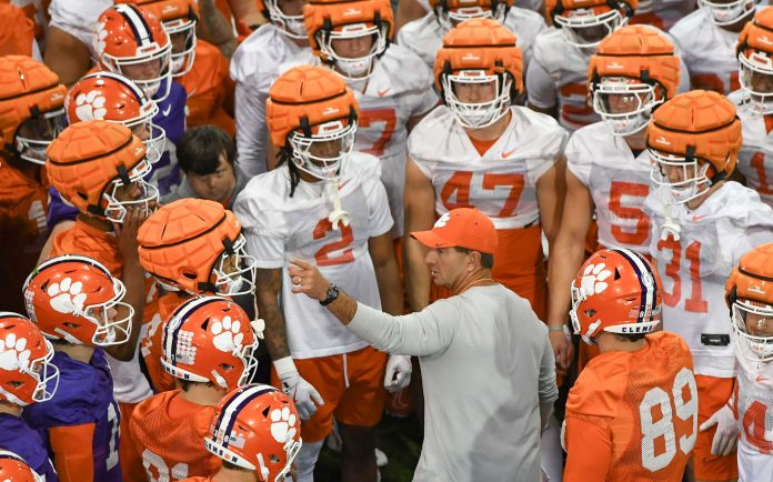 Clemson head coach Dabo Swinney talks with players during the first football practice at the Allen N. Reeves Football Complex at Clemson University in Clemson, S.C. Friday, February 28, 2025.
