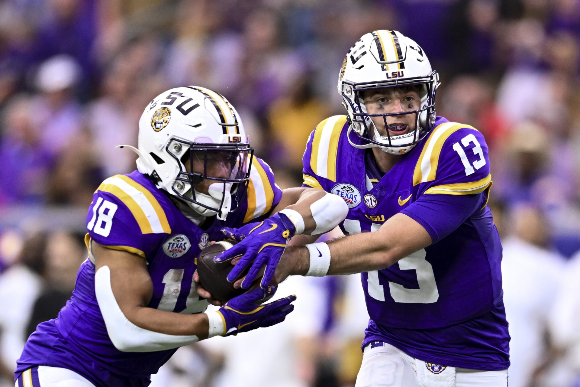 LSU Tigers quarterback Garrett Nussmeier (13) hands off the ball to running back Josh Williams (18) during the first half against the Baylor Bears at NRG Stadium. The Tigers defeat the Bears 44-31.