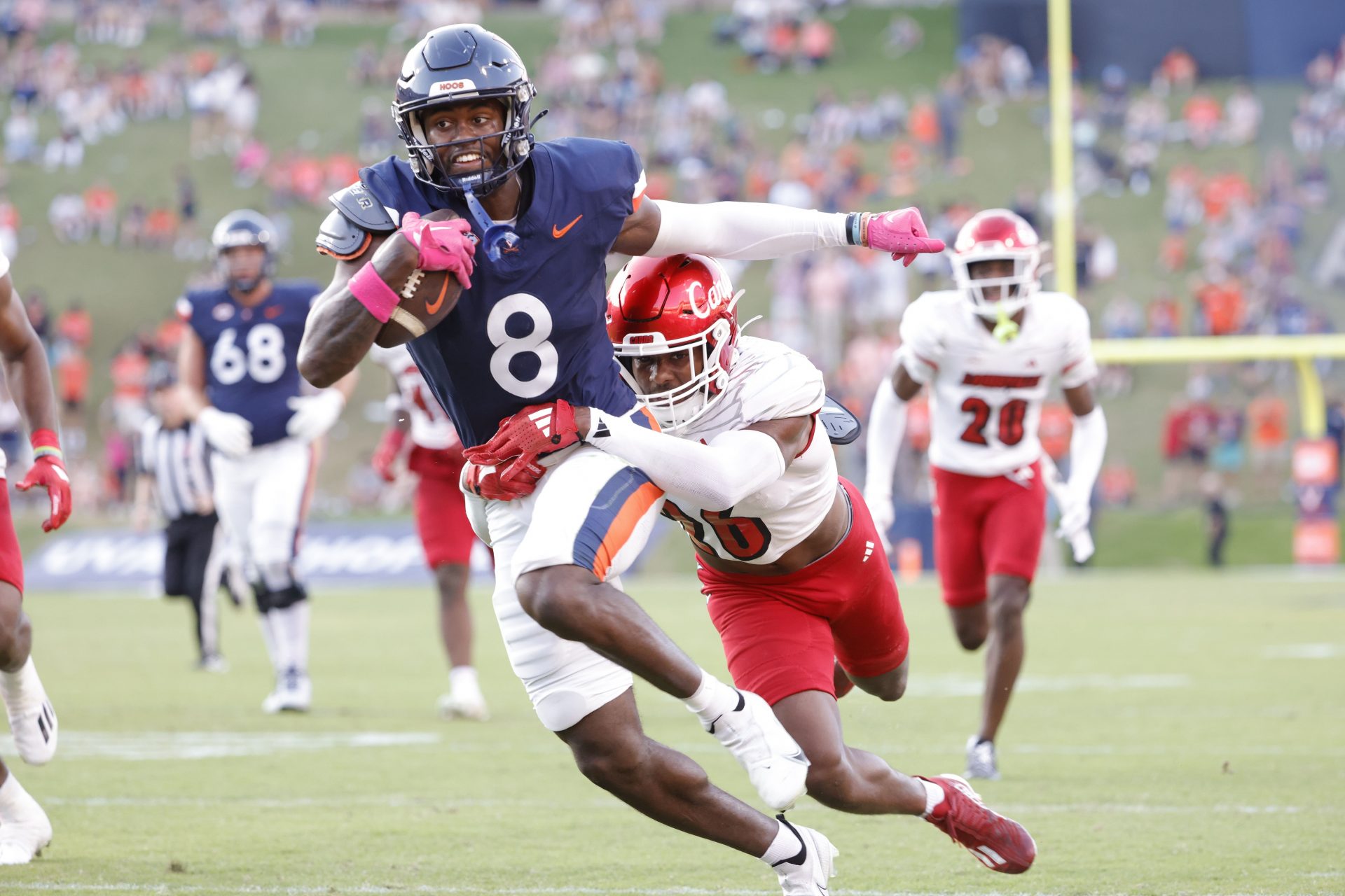Virginia Cavaliers wide receiver Malachi Fields (8) carries the ball as Louisville Cardinals defensive back M.J. Griffin (26) defends during the second half at Scott Stadium.