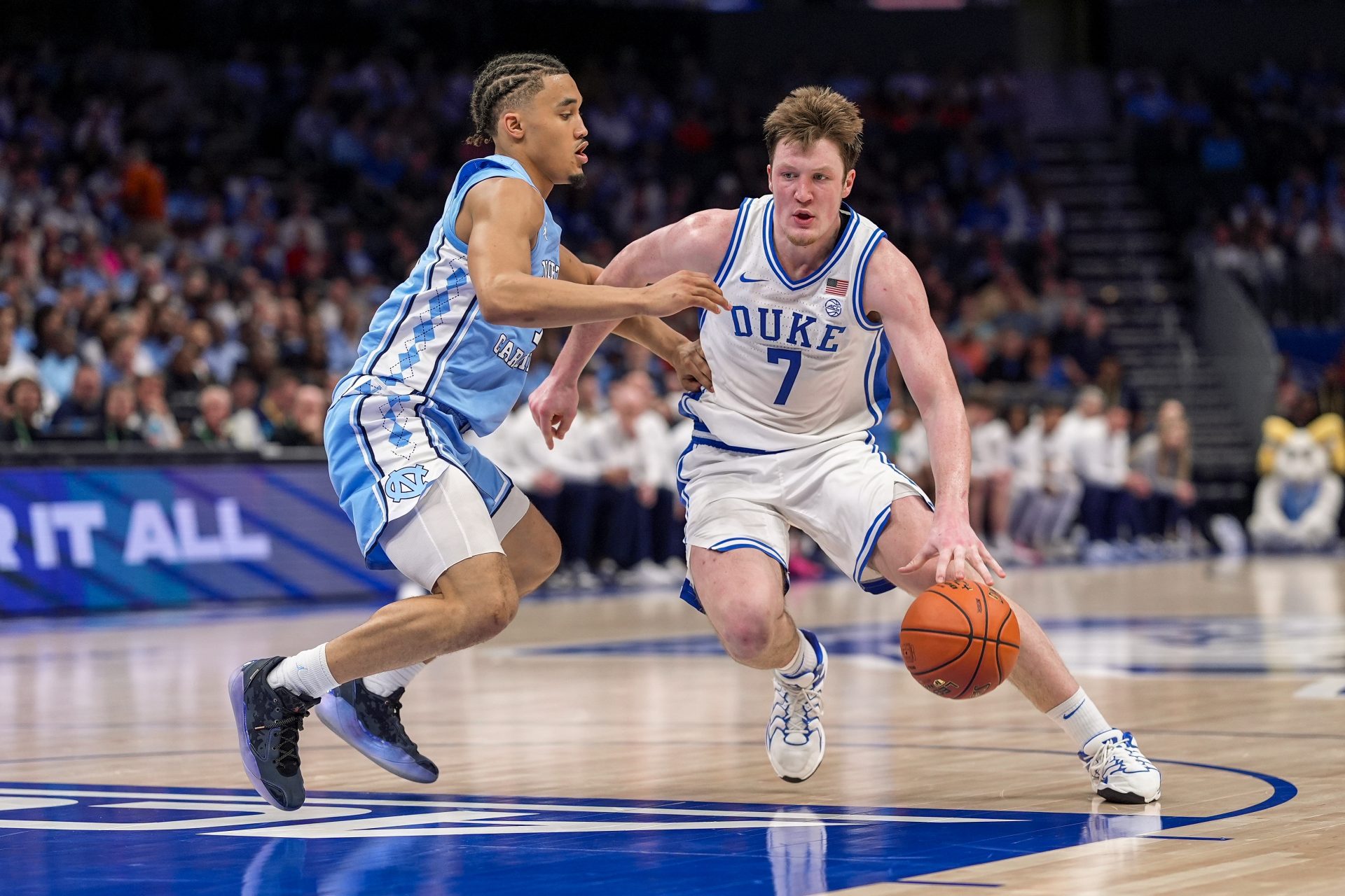 Duke Blue Devils guard Kon Knueppel (7) drives to the basket against North Carolina Tar Heels guard Seth Trimble (7) during the second half at Spectrum Center.