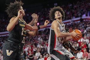 Georgia Bulldogs forward Asa Newell (14) controls the ball behind Vanderbilt Commodores guard Tyler Tanner (3) during the first half at Stegeman Coliseum.