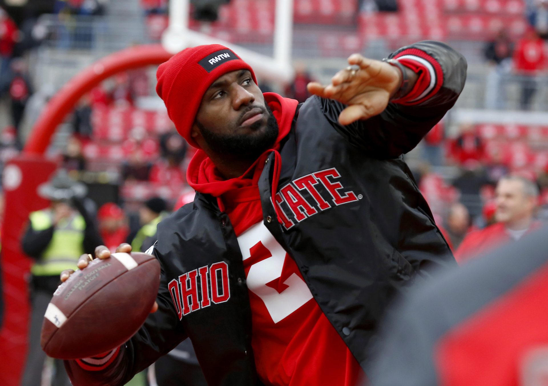 Cleveland Cavaliers player LeBron James plays catch with the Ohio State Buckeyes team before the game against the Michigan Wolverines at Ohio Stadium.