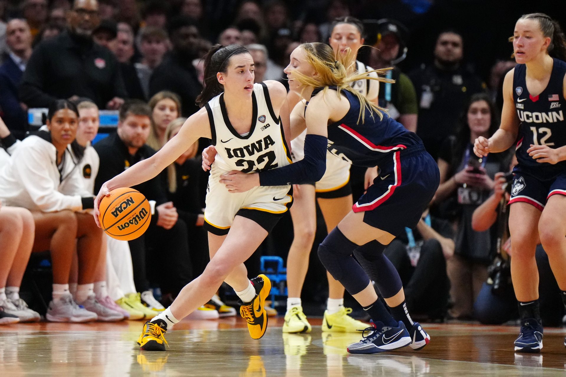 Iowa Hawkeyes guard Caitlin Clark (22) controls the ball against Connecticut Huskies guard Paige Bueckers (5) in the fourth quarter in the semifinals of the Final Four of the womens 2024 NCAA Tournament at Rocket Mortgage FieldHouse.