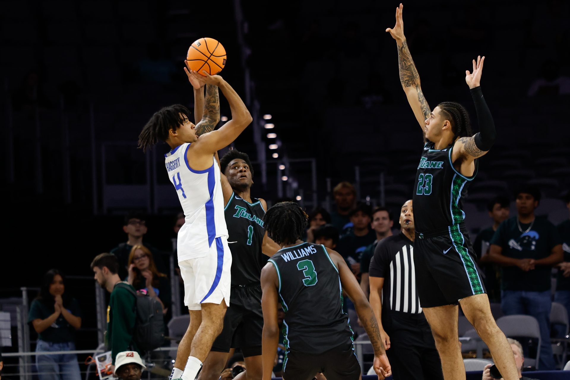 Memphis Tigers guard PJ Haggerty (4) shoots as Tulane Green Wave center Percy Daniels (23) defends during the first half at Dickies Arena.