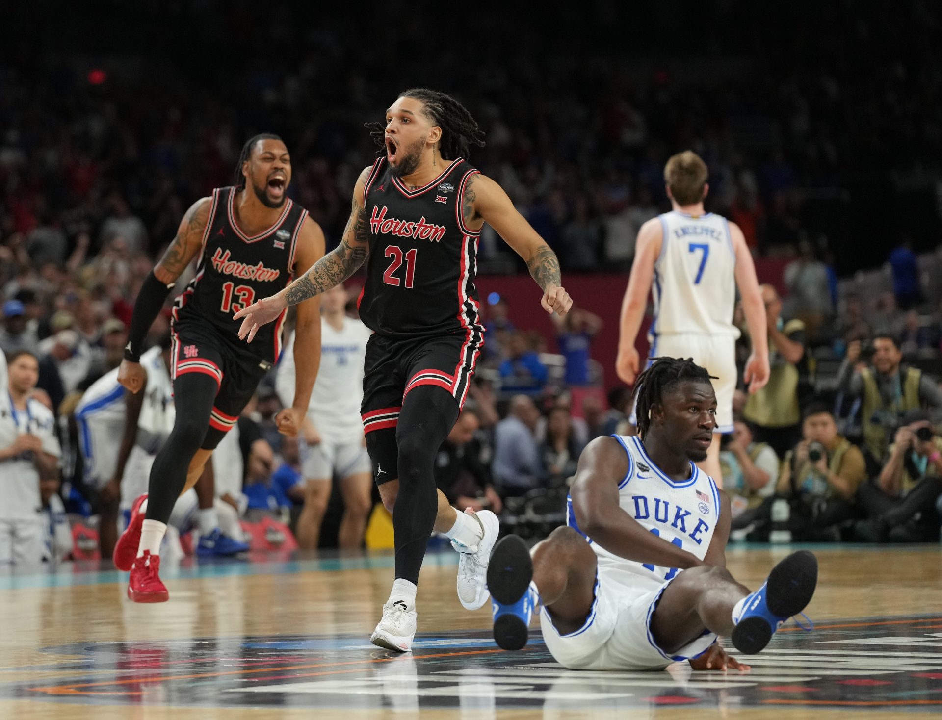 Houston Cougars guard Emanuel Sharp (21) and Houston Cougars forward J'Wan Roberts (13) celebrate defeating the Duke Blue Devils in the semifinals of the men's Final Four of the 2025 NCAA Tournament at the Alamodome.