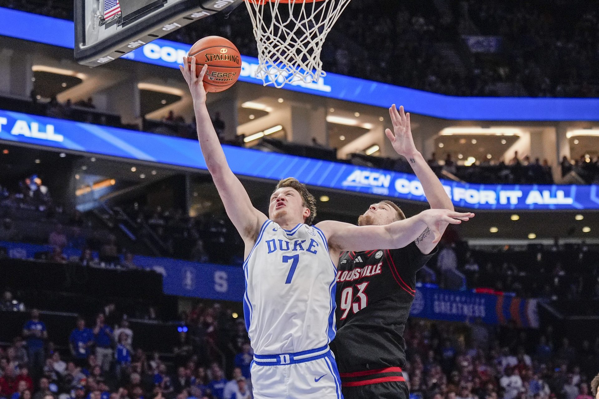 Duke Blue Devils guard Kon Knueppel (7) goes to the basket chased by Louisville Cardinals forward Noah Waterman (93) during the 2025 ACC Conference Championship game at Spectrum Center.