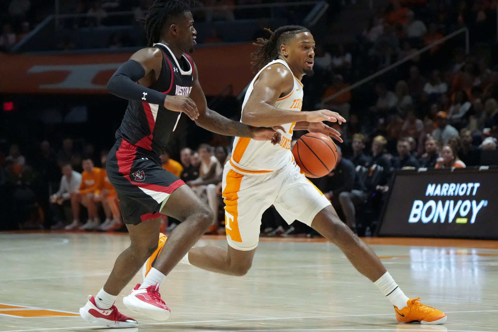 Tennessee's Chaz Lanier (2) moves the ball while guarded by Austin Peay's Tekao Carpenter (2) during an NCAA college basketball game