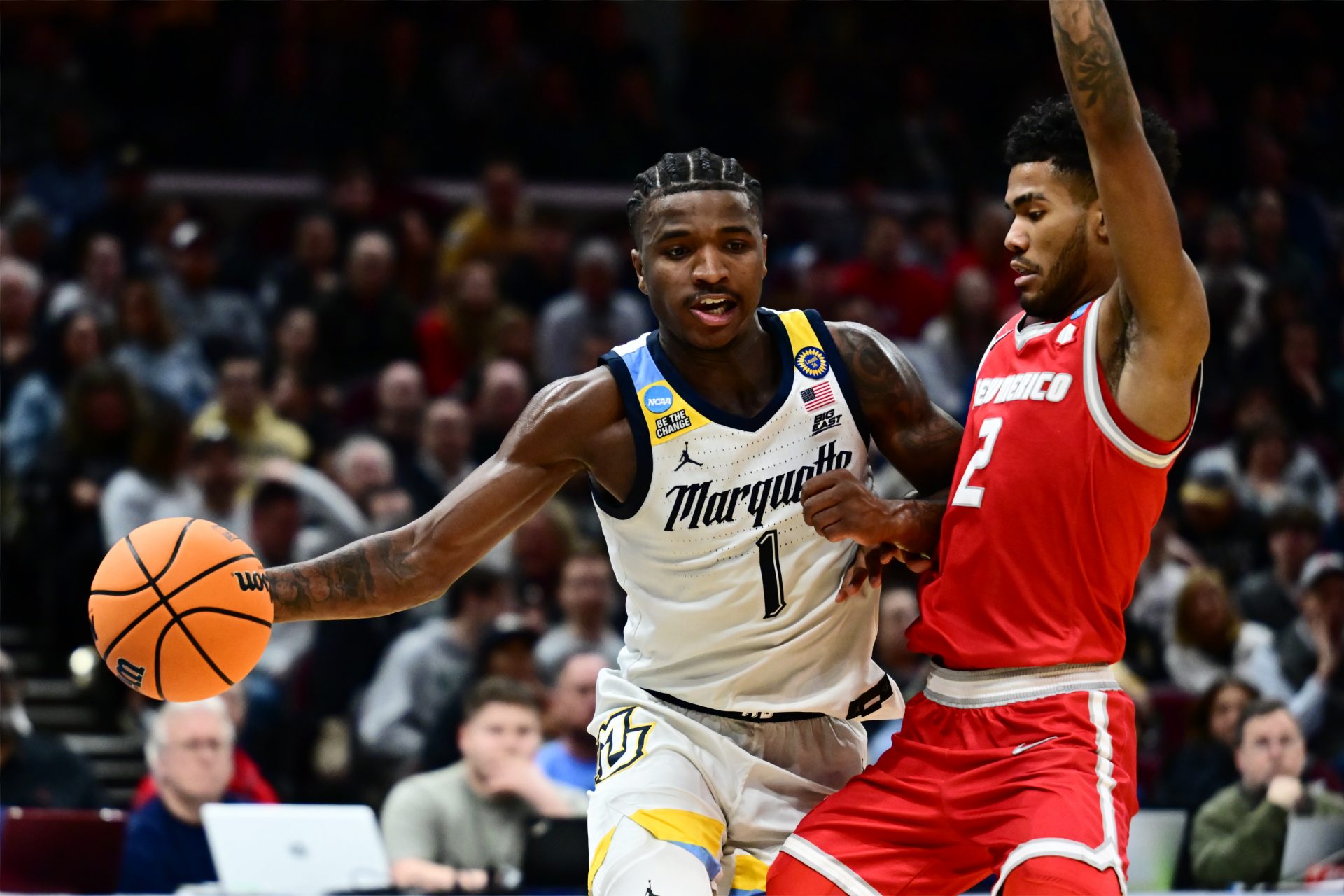 Marquette Golden Eagles guard Kam Jones (1) plays the ball defended by New Mexico Lobos guard Donovan Dent (2) in the second half during the NCAA Tournament First Round at Rocket Arena.