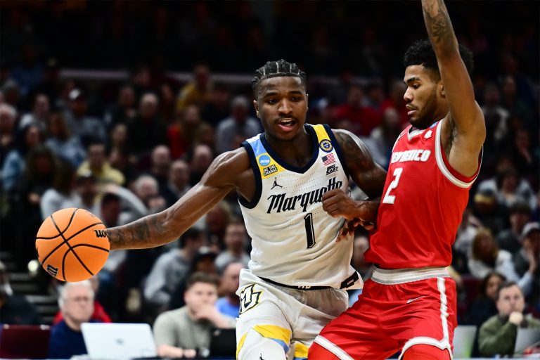 Marquette Golden Eagles guard Kam Jones (1) plays the ball defended by New Mexico Lobos guard Donovan Dent (2) in the second half during the NCAA Tournament First Round at Rocket Arena.