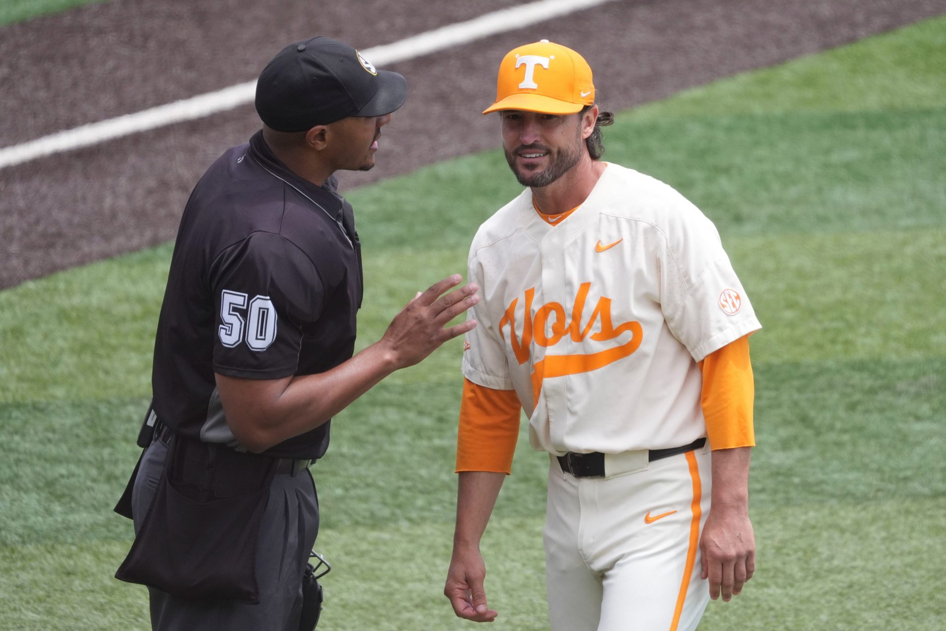Tennessee baseball coach Tony Vitello talks with plate umpire Javerro January during an NCAA baseball game against Auburn