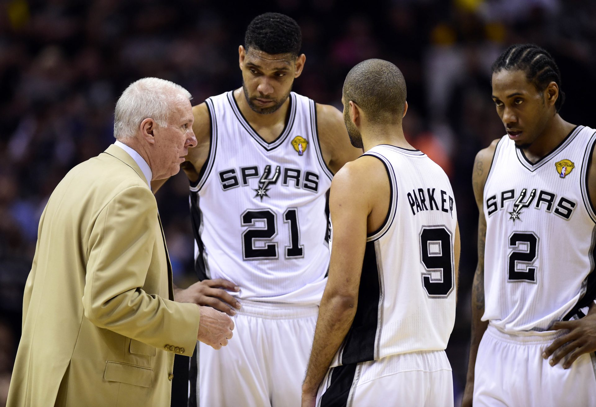 San Antonio Spurs head coach Gregg Popovich talks to forward Tim Duncan (21) guard Tony Parker (9) and forward Kawhi Leonard (2) against the Miami Heat in game two of the 2014 NBA Finals at AT&T Center. The Heat won 98-96.