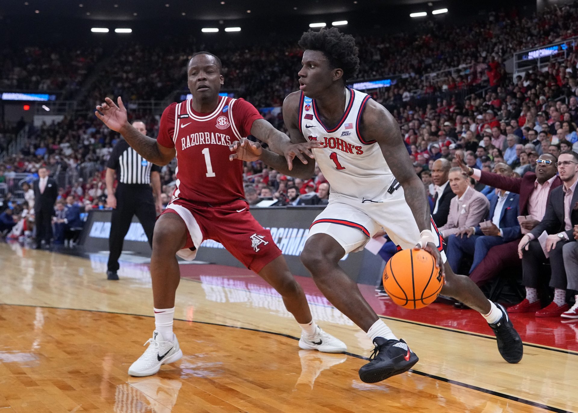 St. John's Red Storm guard Kadary Richmond (1) drives against Arkansas Razorbacks guard Johnell Davis (1) during the first half of a second round men’s NCAA Tournament game at Amica Mutual Pavilion.