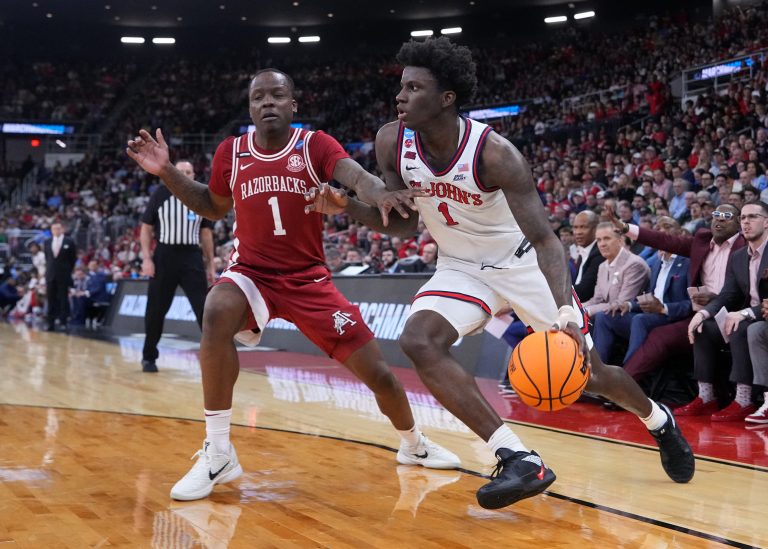 St. John's Red Storm guard Kadary Richmond (1) drives against Arkansas Razorbacks guard Johnell Davis (1) during the first half of a second round men’s NCAA Tournament game at Amica Mutual Pavilion.
