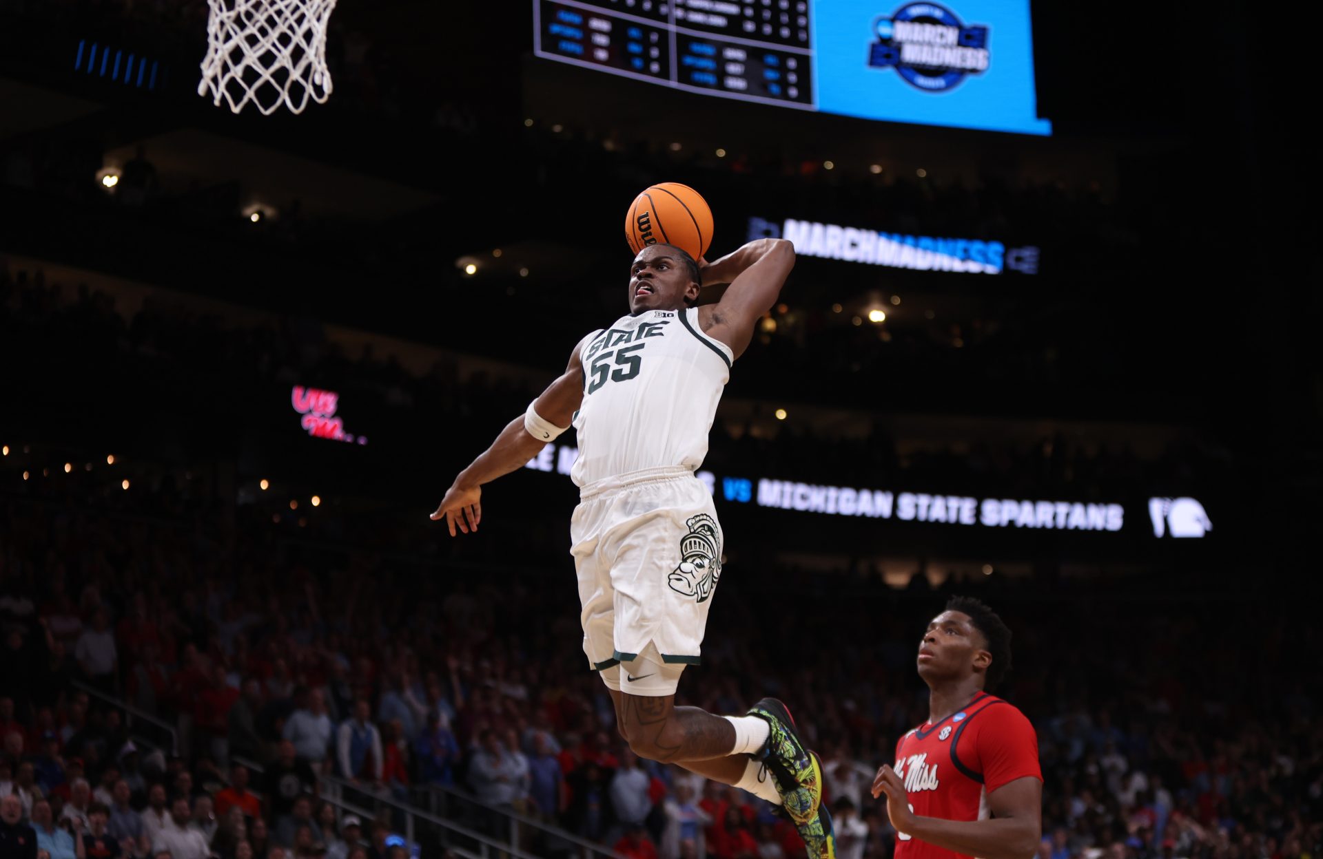 Michigan State Spartans forward Coen Carr (55) dunks against Mississippi Rebels forward Malik Dia (0) in the second half of a South Regional semifinal of the 2025 NCAA tournament at State Farm Arena.