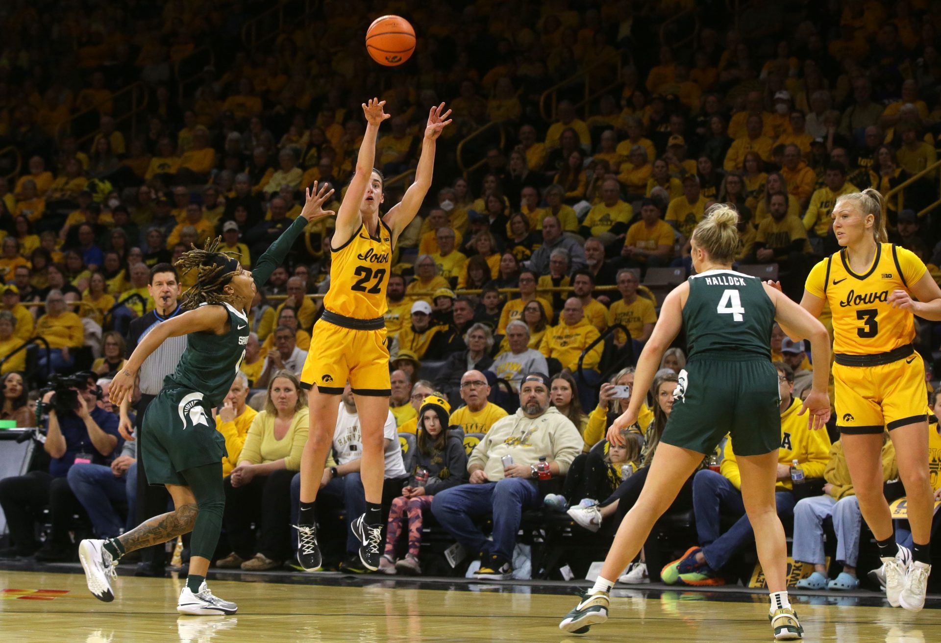 Iowa’s Caitlin Clark (22) attempts a three-point shot against Michigan State Tuesday, Jan. 2, 2024 at Carver-Hawkeye Arena.