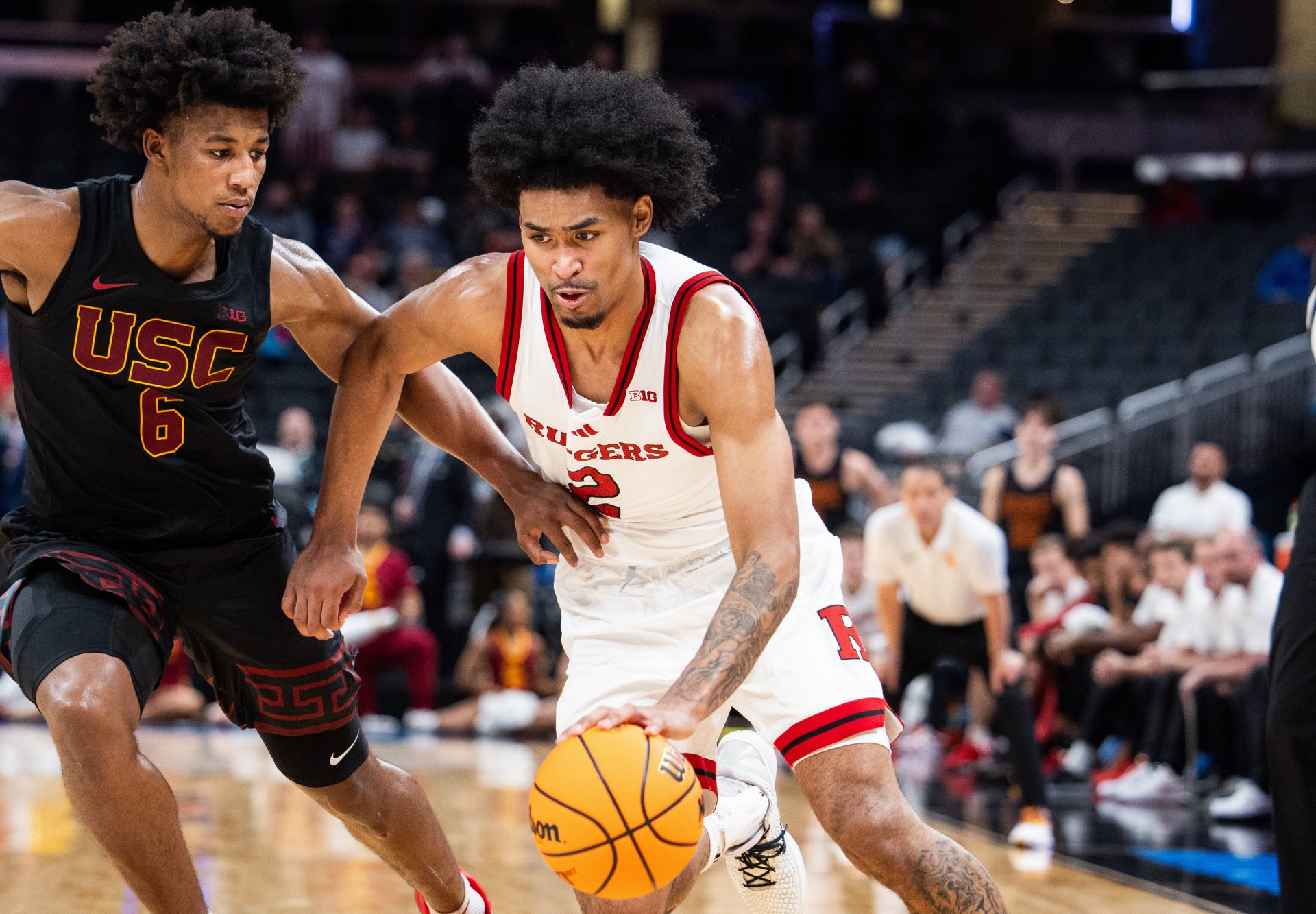 Rutgers Scarlet Knights guard Dylan Harper (2) dribbles the ball while USC Trojans guard Wesley Yates III (6) defends in the second half at Gainbridge Fieldhouse. Mandatory Credit: Trev