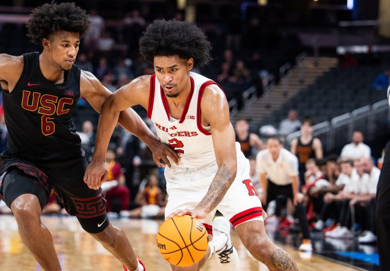 Rutgers Scarlet Knights guard Dylan Harper (2) dribbles the ball while USC Trojans guard Wesley Yates III (6) defends in the second half at Gainbridge Fieldhouse. Mandatory Credit: Trev