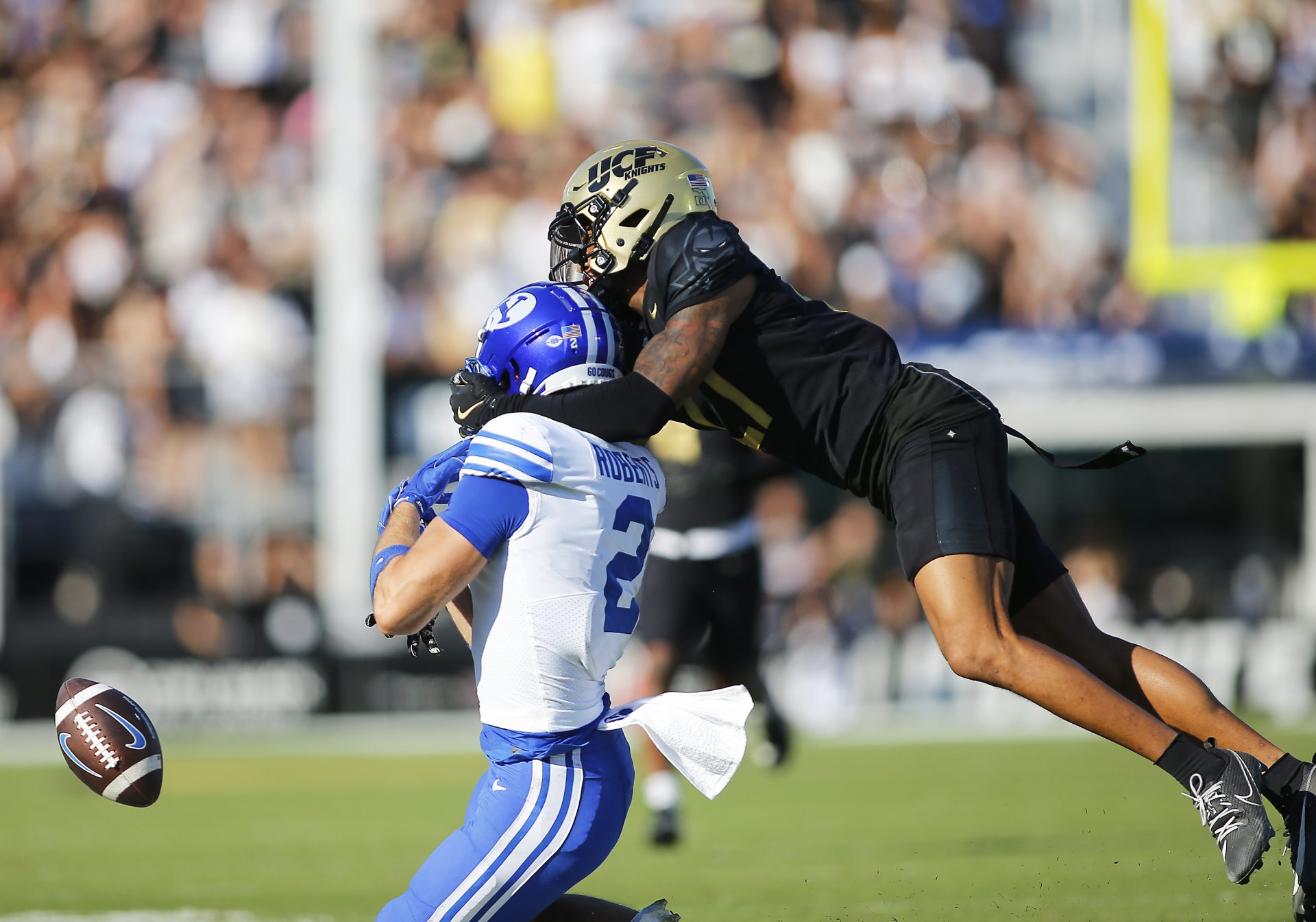 Central Florida Knights cornerback Chasen Johnson (27) is flagged for pass interference against Brigham Young Cougars wide receiver Chase Roberts (2) in the first half at FBC Mortgage Stadium.