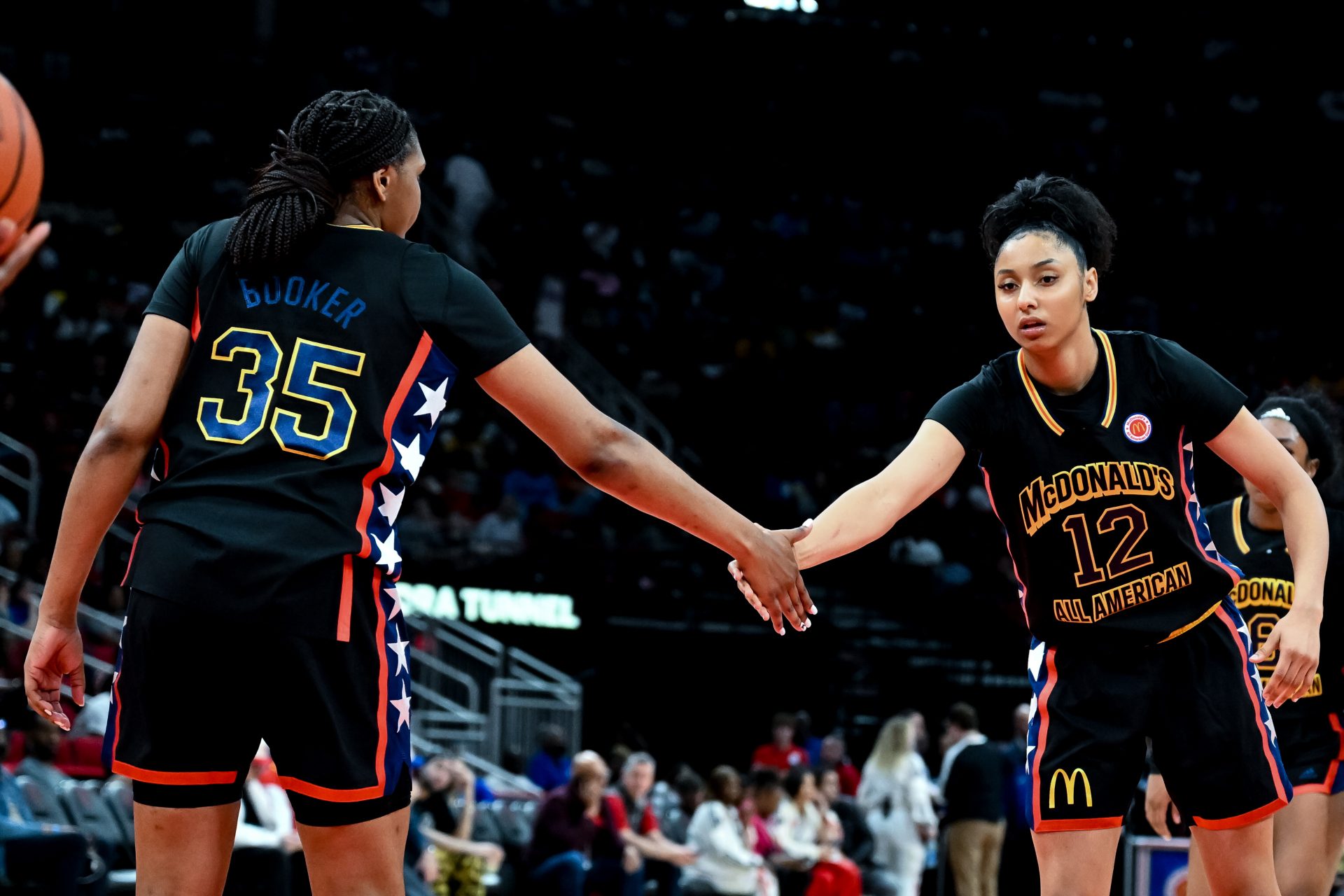 McDonald's All American West guard JuJu Watkins (12) and forward Madison Booker (35) high five during the second half against the McDonald's All American East at Toyota Center.