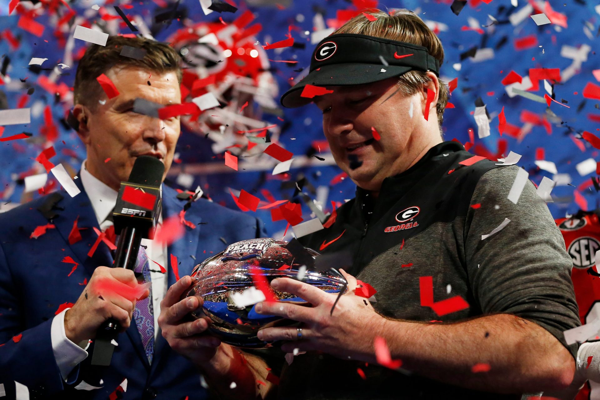 Georgia coach Kirby Smart is presented with the Chick-fil-A Peach Bowl trophy after winning the Chick-fil-A Peach Bowl NCAA College Football Playoff semifinal game between Ohio State and Georgia on Sunday, Jan 1, 2022, in Atlanta. Georgia won 42-41.

News Joshua L Jones