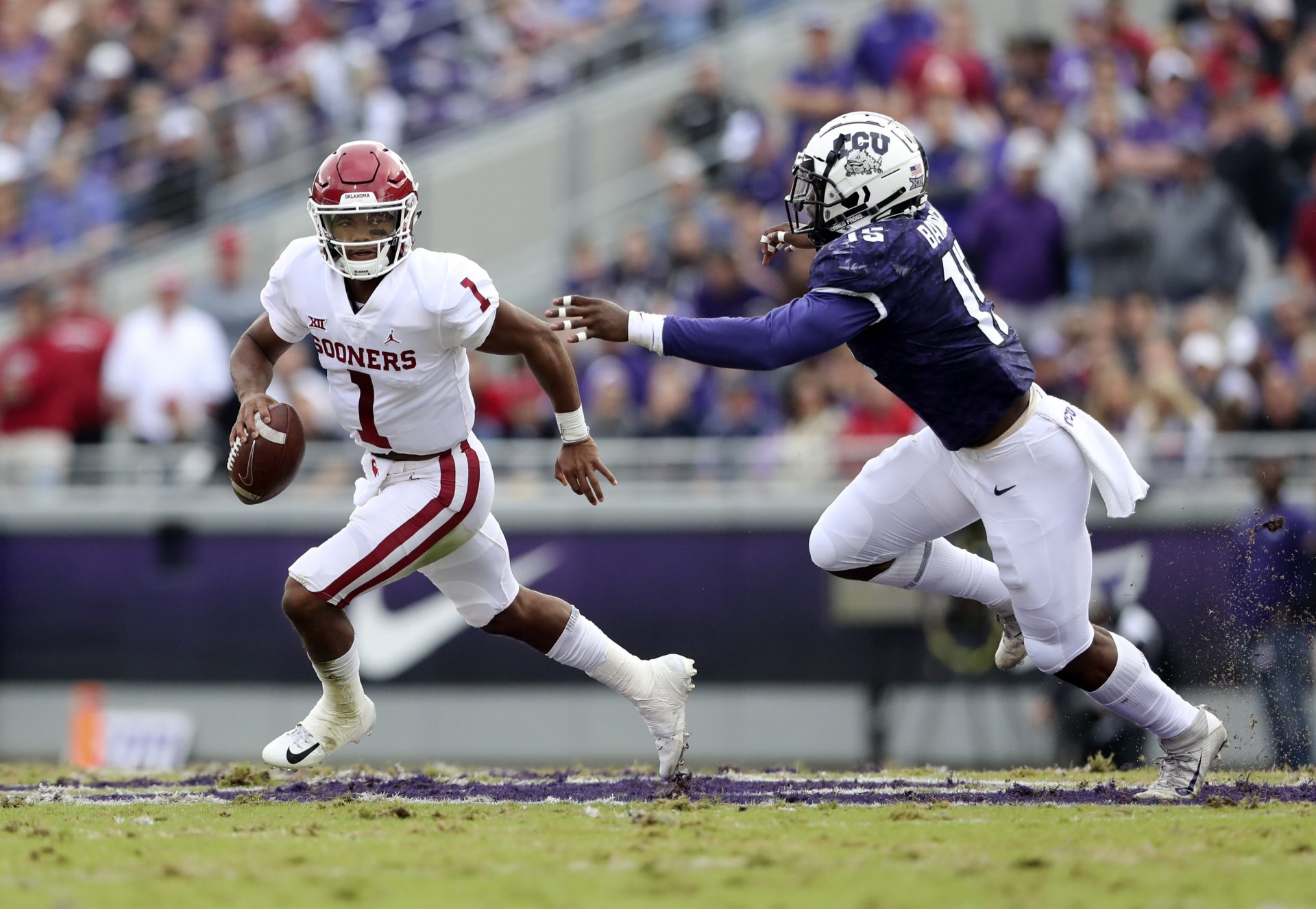 Oklahoma Sooners quarterback Kyler Murray (1) runs past TCU Horned Frogs defensive end Ben Banogu (15) during the first half at Amon G. Carter Stadium.