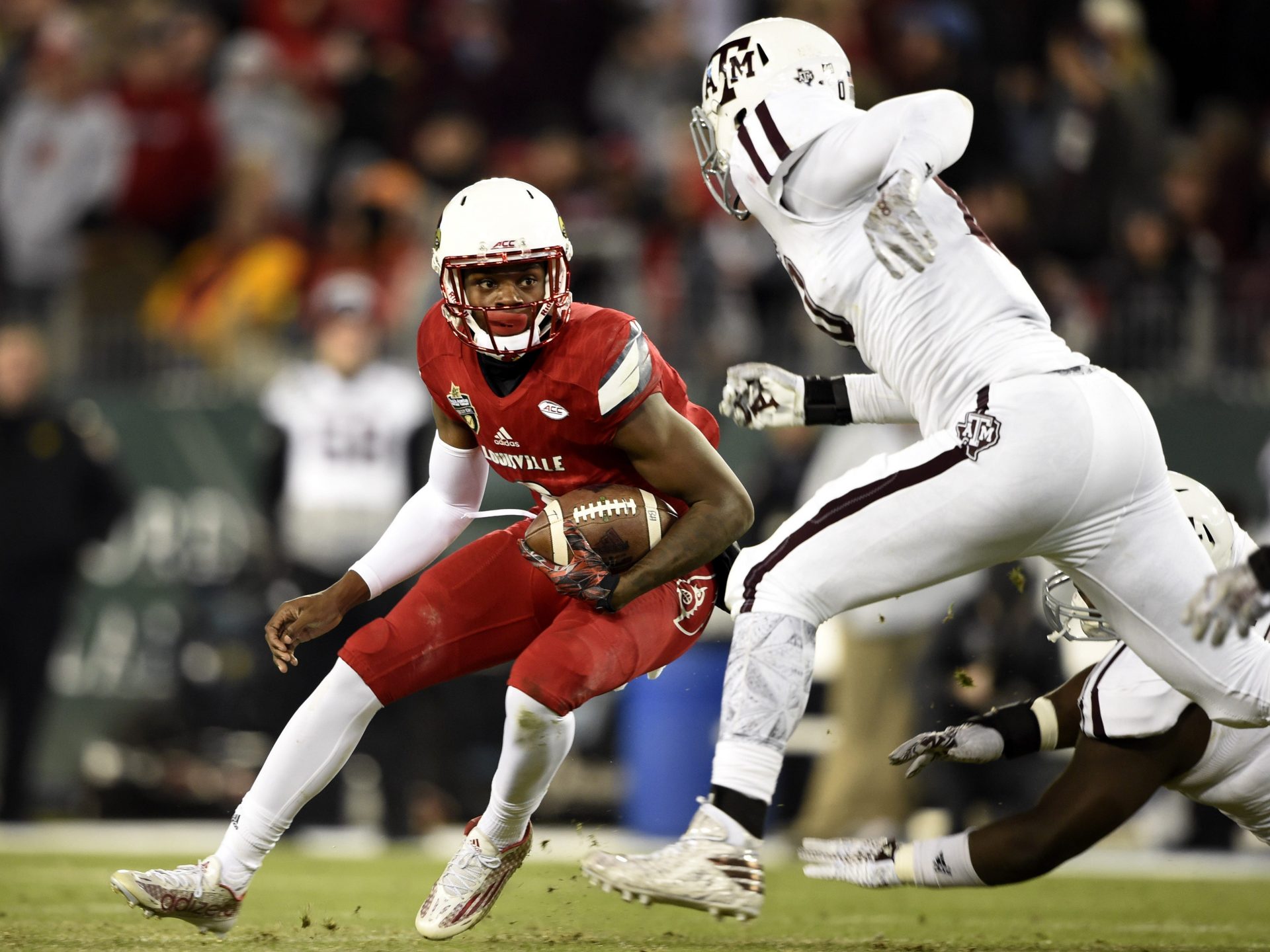 Louisville quarterback Lamar Jackson, left, tries to get past a couple of Texas A&M defenders during the second quarter of the Music City Bowl at Nissan Stadium Dec. 30, 2015. Louisville won 27-21 before a crowd of 50,478.

Nas Music City Bowl