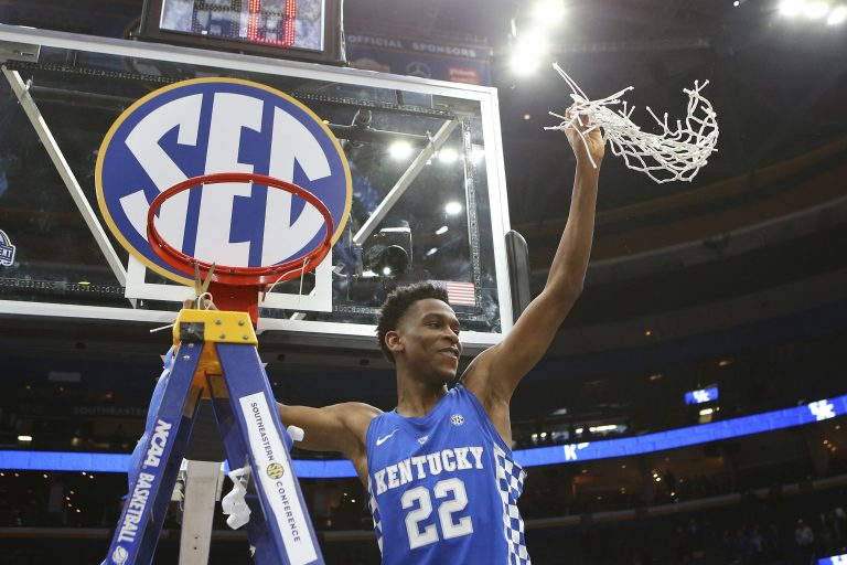 Kentucky Wildcats guard Shai Gilgeous-Alexander (22) cuts down the net after the Wildcats defeat the Tennessee Volunteers in the SEC Conference Tournament Championship game at Scottrade Center. Kentucky won 77-72.