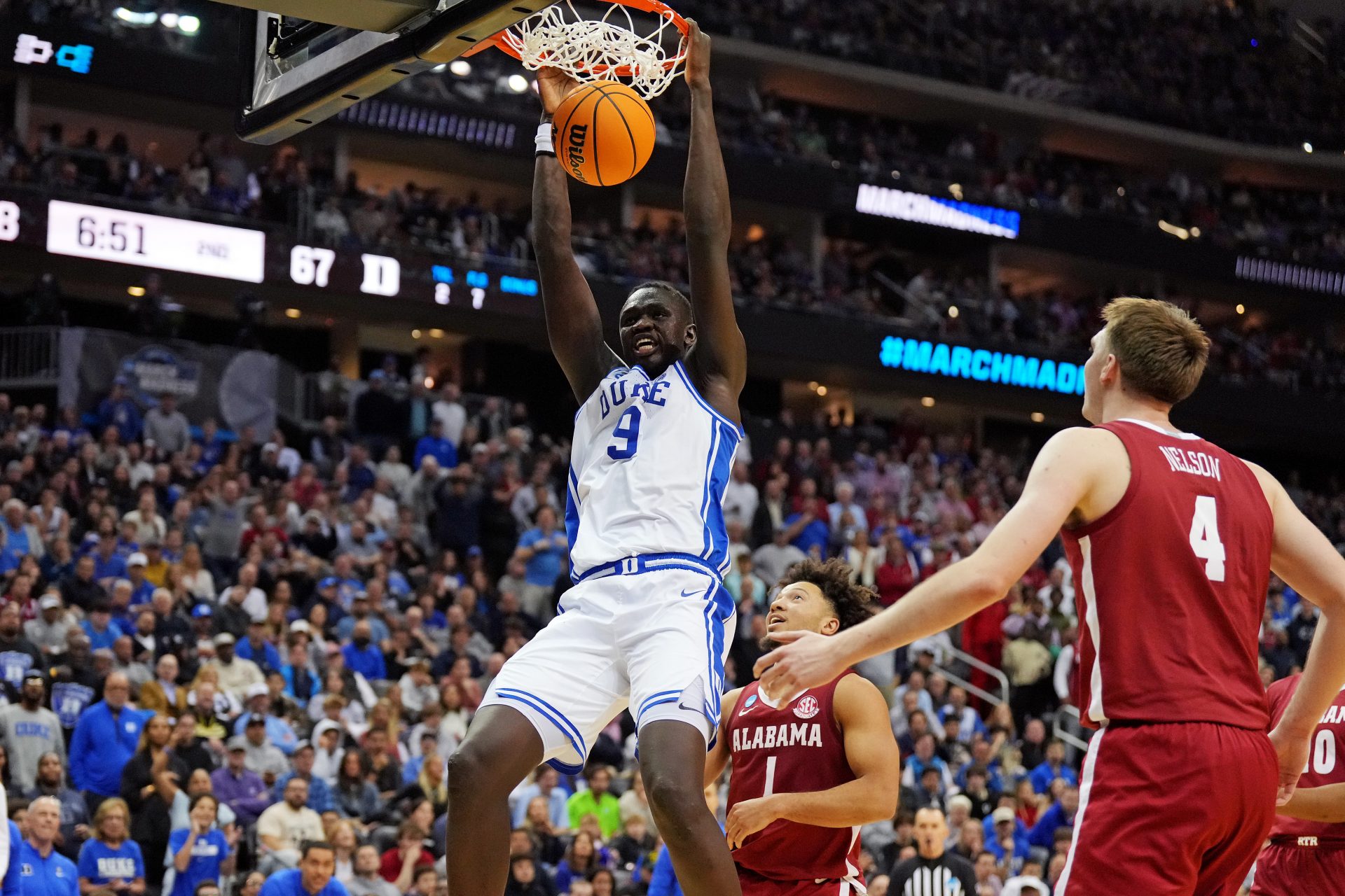 Duke Blue Devils center Khaman Maluach (9) dunks the ball against Alabama Crimson Tide forward Grant Nelson (4) during the second half in the East Regional final of the 2025 NCAA tournament at Prudential Center.