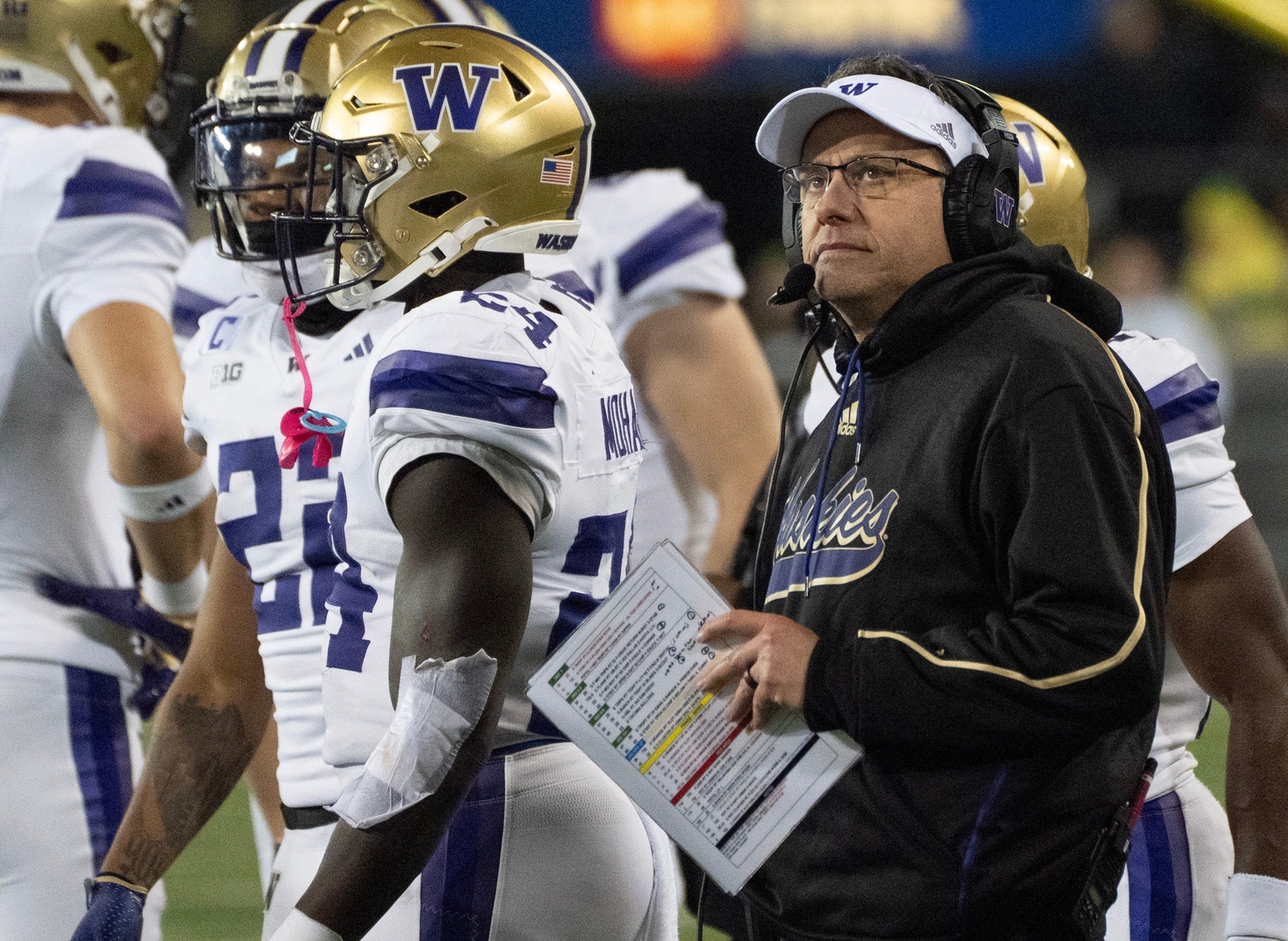 Washington football coach Jedd Fisch looks at the scoreboard during the second quarter at Autzen Stadium in Eugene.