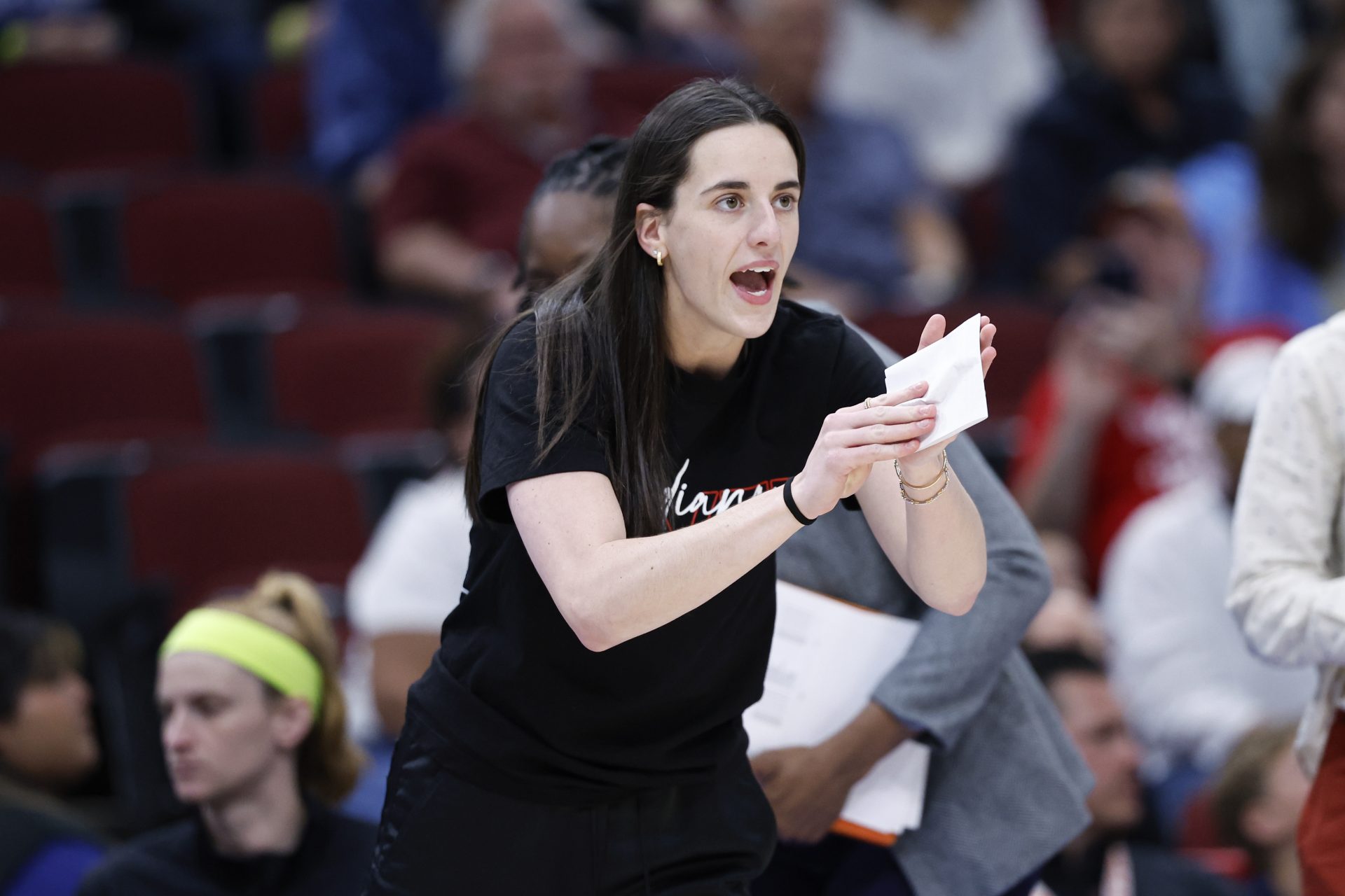 Indiana Fever guard Caitlin Clark (22) applauds her teammates during the first half of a WNBA game against the Chicago Sky at United Center.