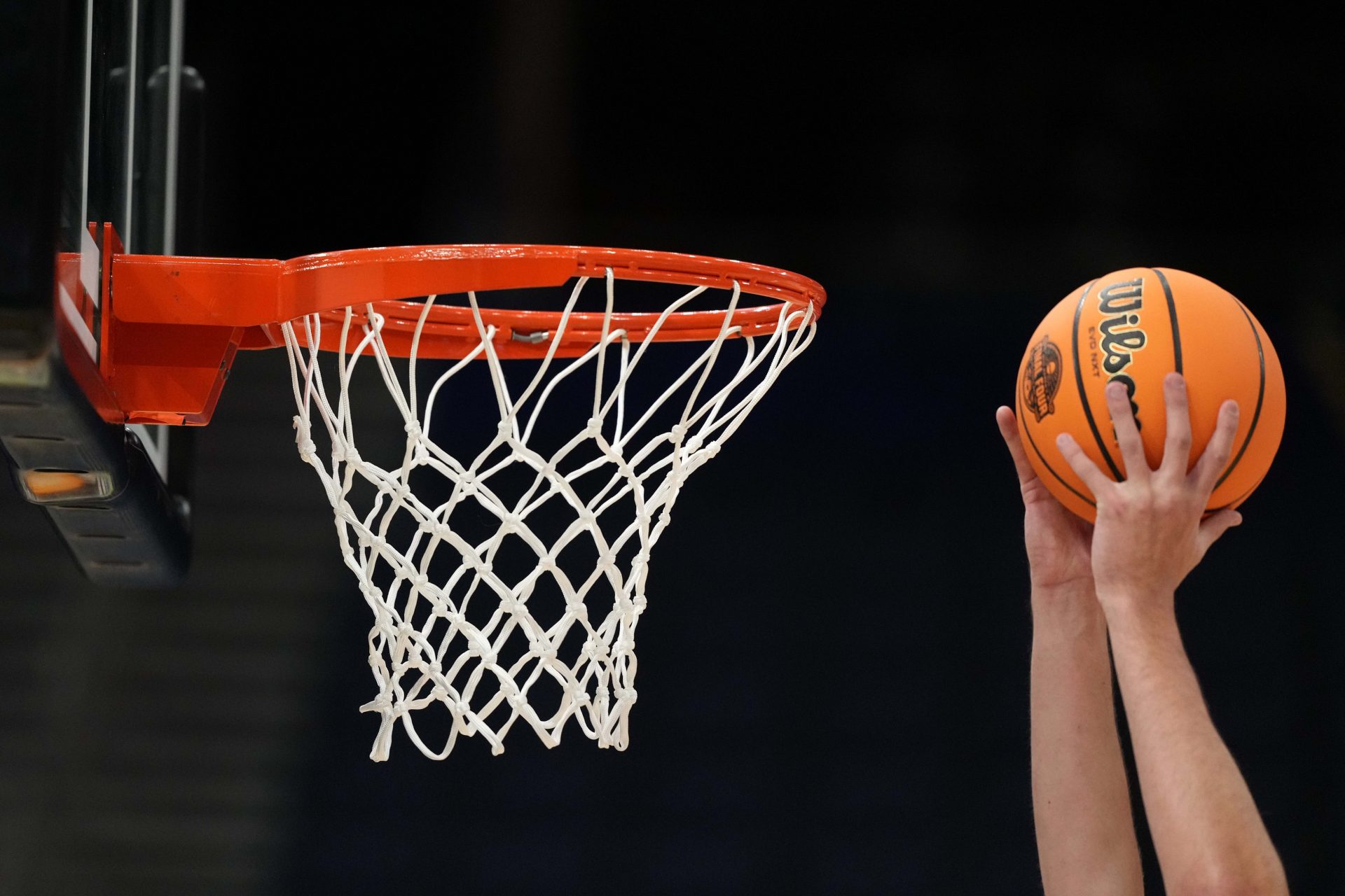 A Wilson EVO Nxt basketball ball with the 2025 NCAA Women's Final Four logo approaches the rim and the net at Amalie Arena.