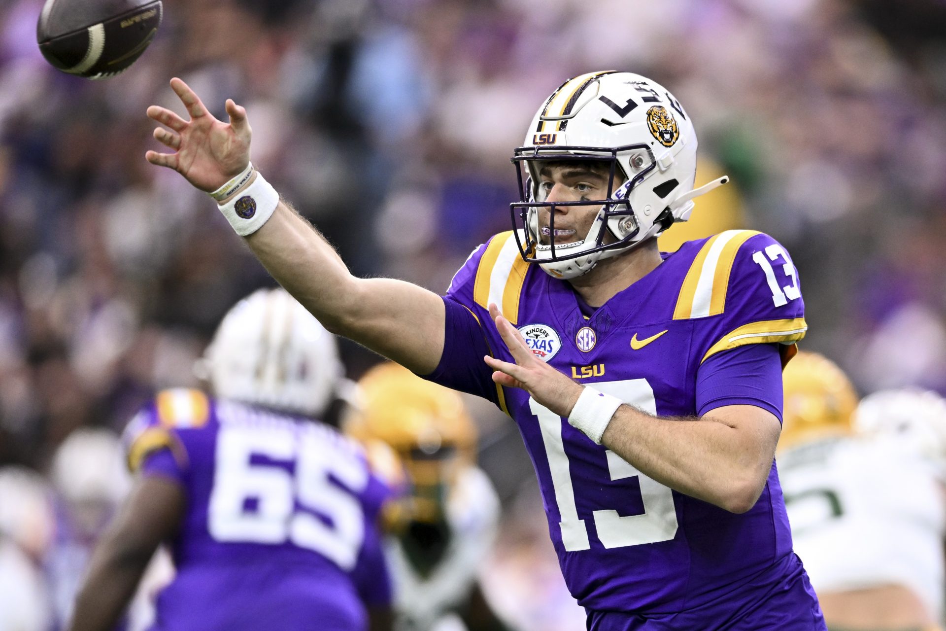 LSU Tigers quarterback Garrett Nussmeier (13) throws a pass during the first quarter against the Baylor Bears at NRG Stadium.
