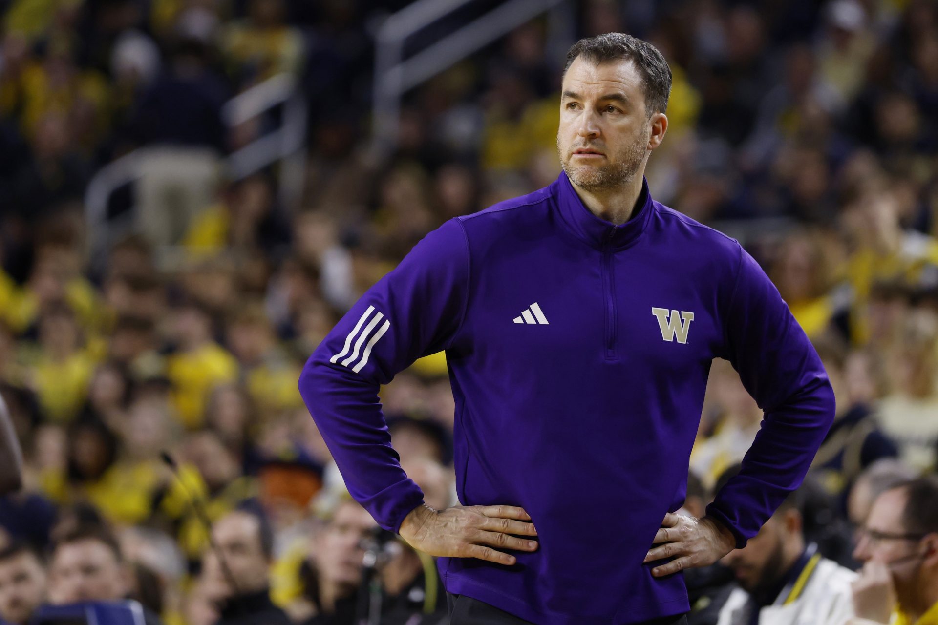 Washington Huskies head coach Danny Sprinkle looks on in the first half against the Michigan Wolverines at Crisler Center.