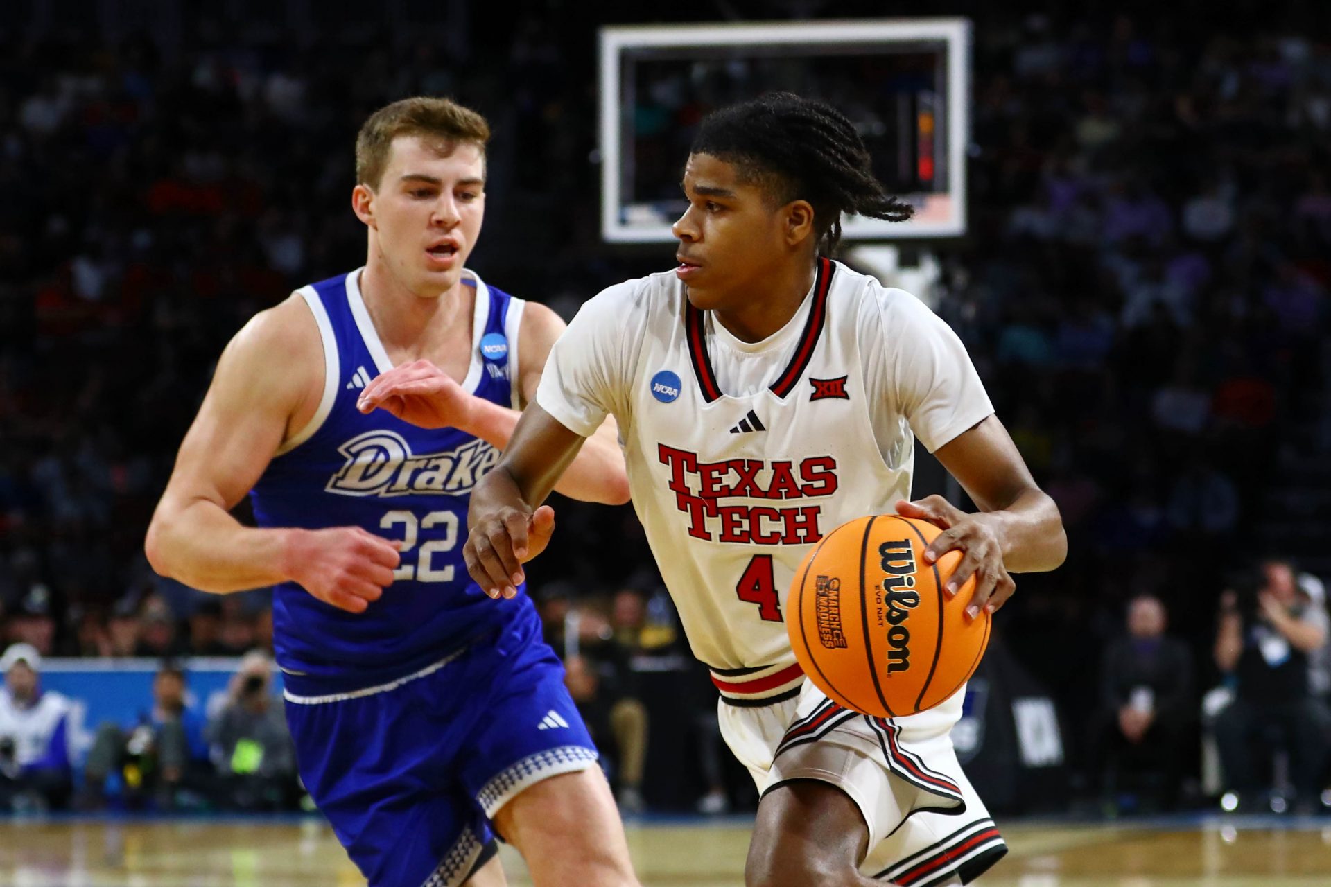 Texas Tech Red Raiders guard Christian Anderson (4) dribbles the ball against Drake Bulldogs guard Mitch Mascari (22) during the first half at Intrust Bank Arena.