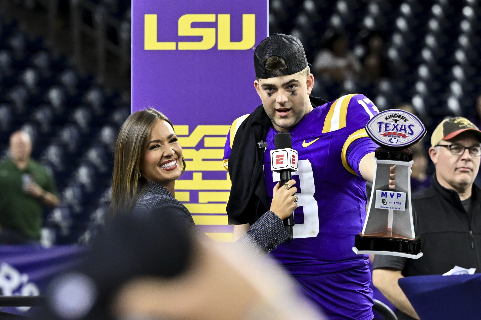 LSU Tigers quarterback Garrett Nussmeier (13) holds up the MVP trophy during a post game interview of the game against the Baylor Bears at NRG Stadium. The Tigers defeat the Bears 44-31.