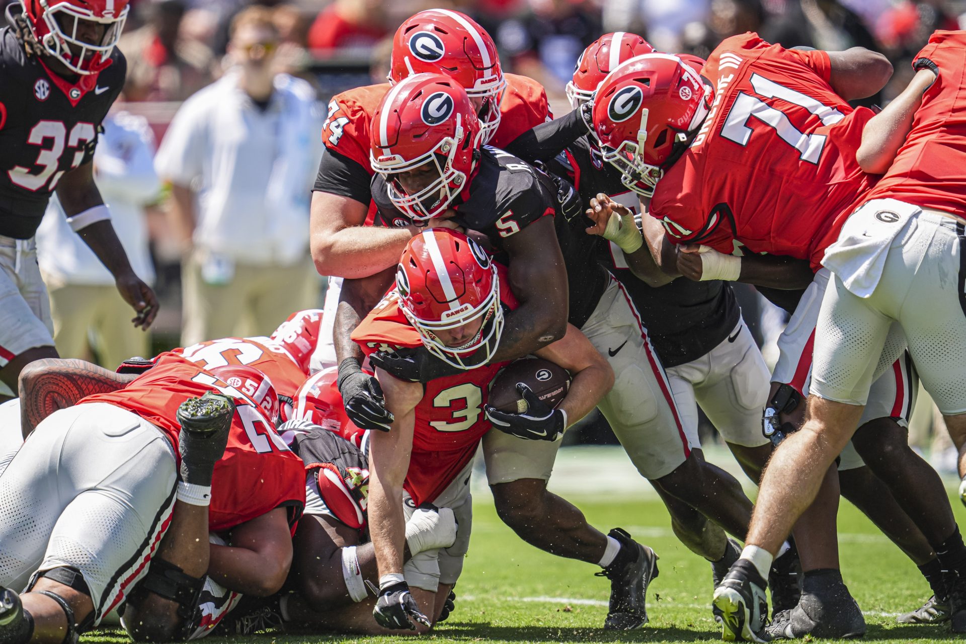 Georgia Bulldogs running back Cash Jones (32) is tackled by inside linebacker Raylen Wilson (5)  during the Georgia Spring game at Sanford Stadium.