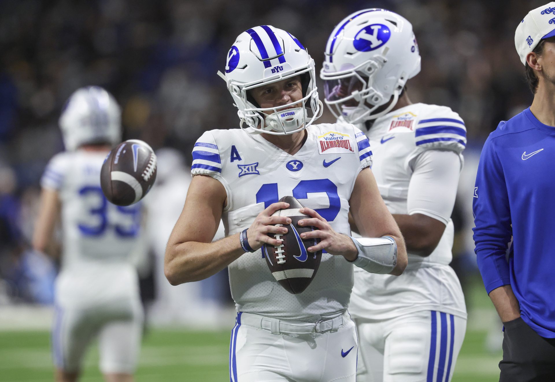 Brigham Young Cougars quarterback Jake Retzlaff (12) warms up before the game against the Colorado Buffaloes at Alamodome.