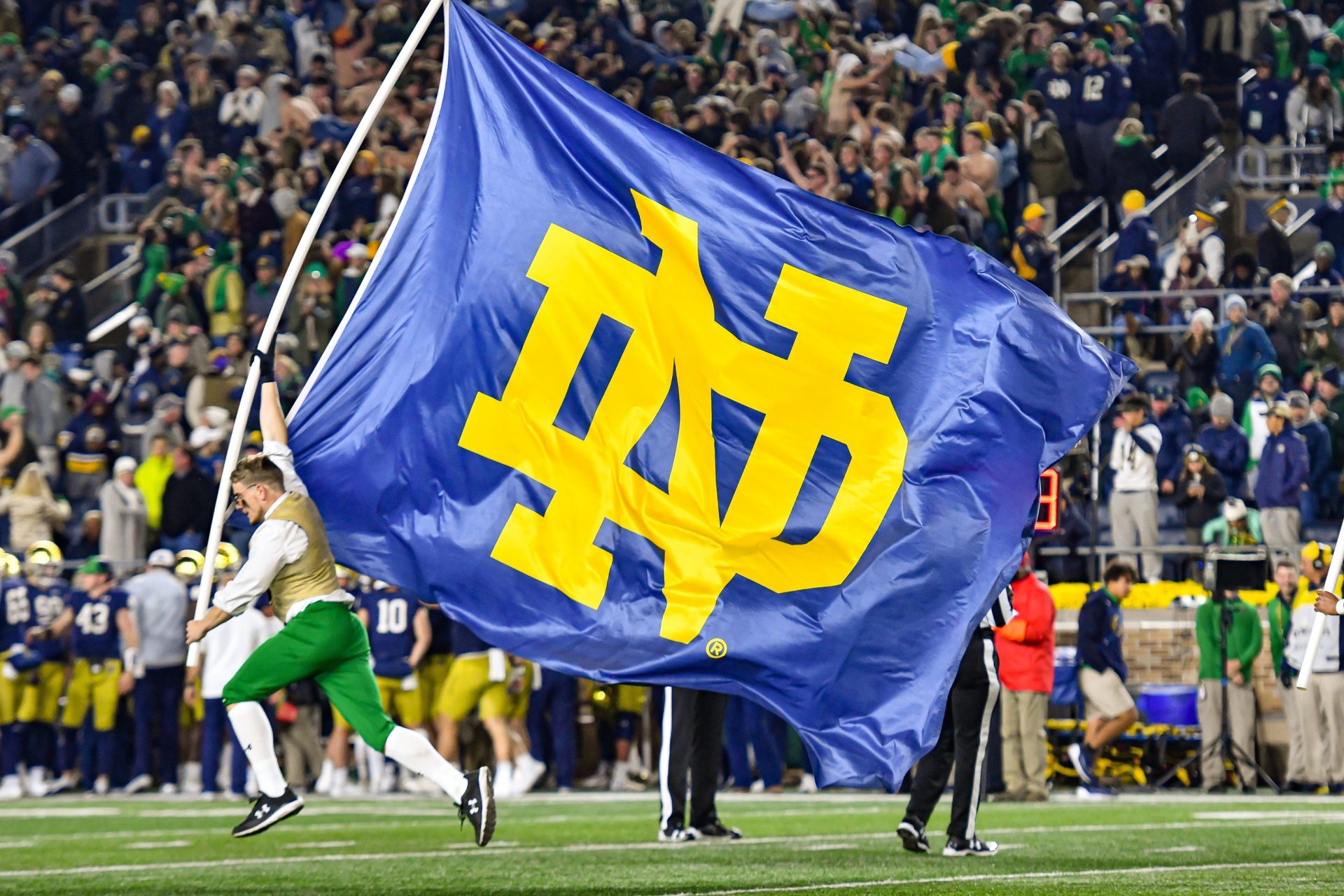 The Notre Dame Leprechaun carries a Notre Dame monogram flag after a Notre Dame touchdown in the fourth quarter against the USC Trojans at Notre Dame Stadium.