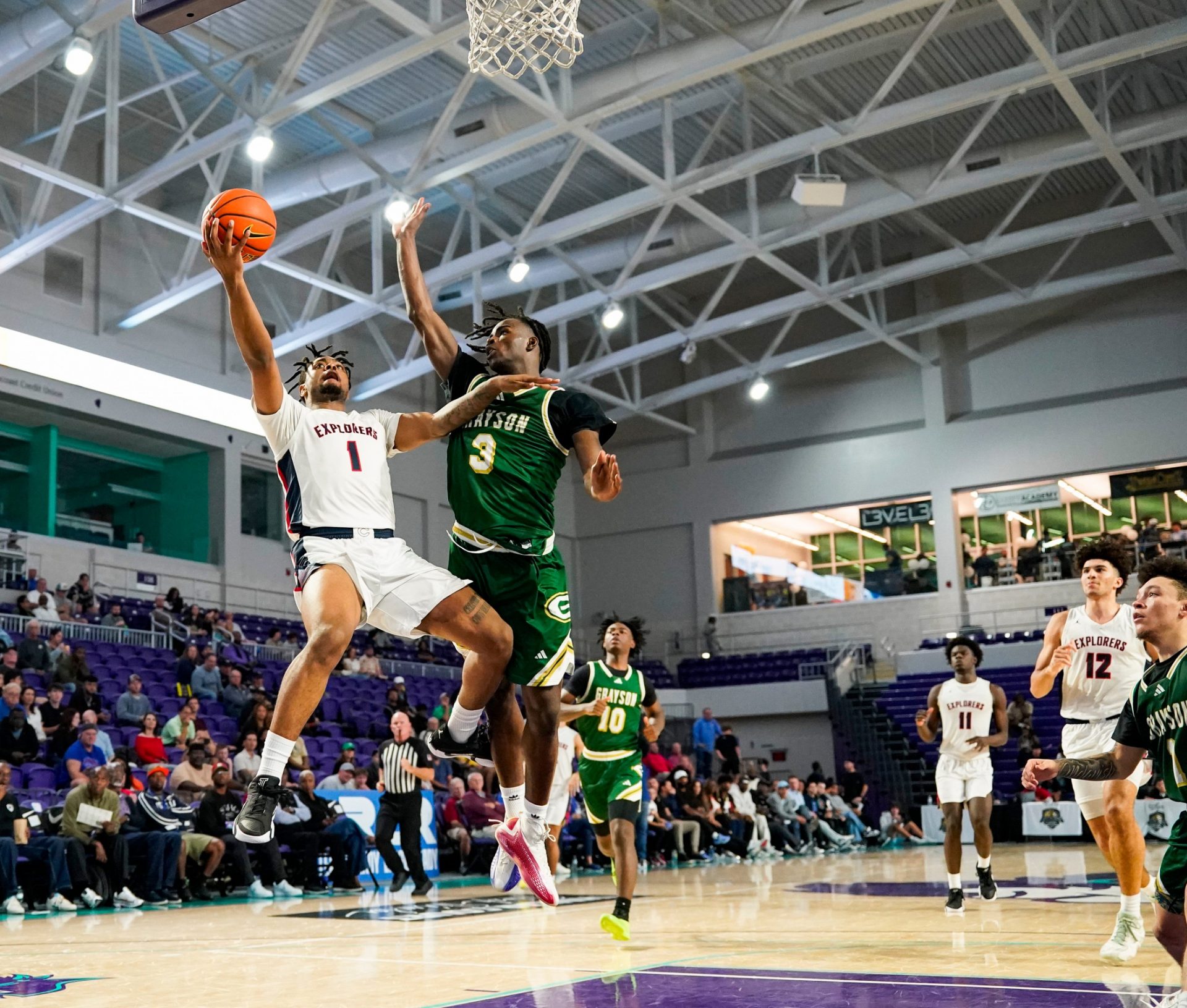Columbus Explorers guard Cello Jackson (1) makes a lay up on a breakaway as Grayson Rams guard Caleb Holt (3) tries to defend during the third quarter of a City of Palms Classic quarterfinal game at Suncoast Credit Union Arena in Fort Myers, Fla., on Friday, Dec. 20, 2024.